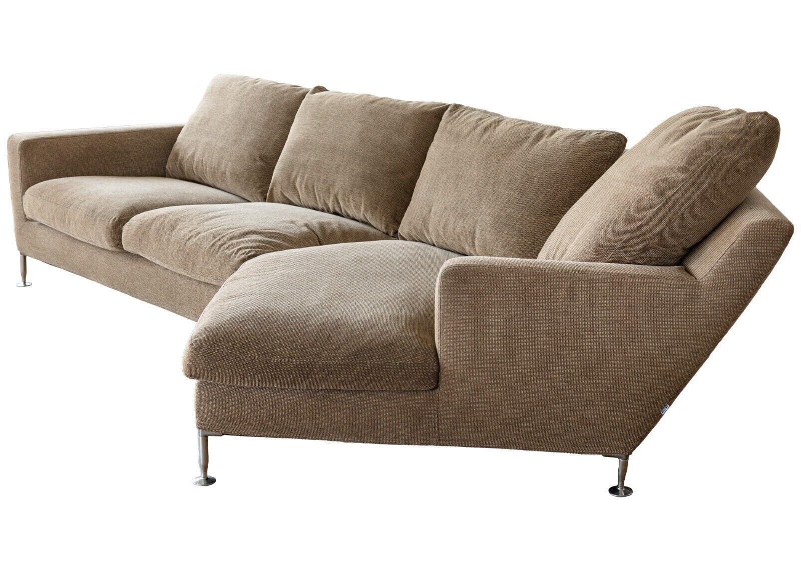 A modern B&B Italia The Harry sofa by Antonio Citterio. A beautifully unique sofa with a modern design. This wonderful sofa features an asymmetrical design, with one side showing a longer seat and backing. This piece sits on chrome metal legs which