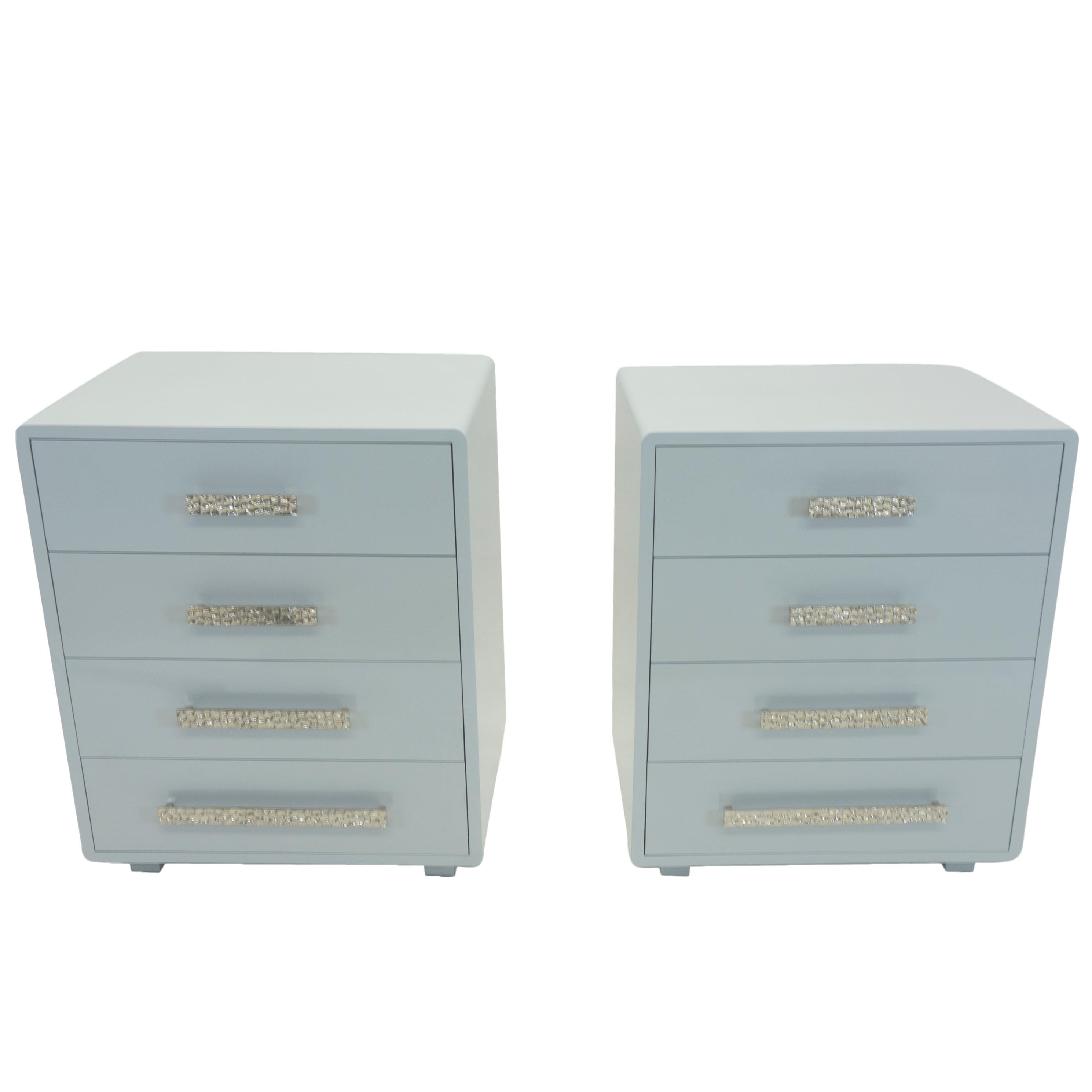 Our ladder bedside tables are both functional and chic. They feature short block legs and rounded edges lacquered in a glossy grey/blue. The tables are equipped with specialty metal handles that are placed in ascending and descending sizes on four