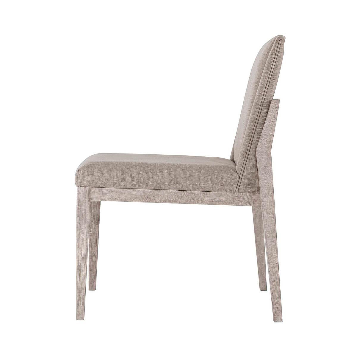 Modern upholstered dining side chair, the brushed beech wood finished in our gowan finish, with an upholstered backrest and bowed seat. Raised on square tapered and out flaring legs. Upholstery is a stain-resistant performance fabric.

Draper