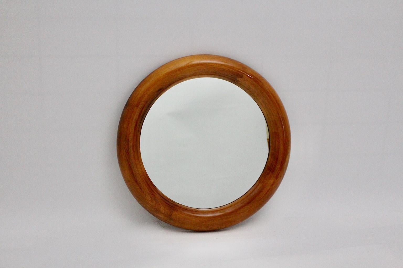 Modern vintage round shaped vintage wall mirror from natural lacquered beech and mirror glass.
The wall mirror features a beautiful warm vivid color tone which is very similar to cherrywood and demostrates stunning warmth and depth.
Through its