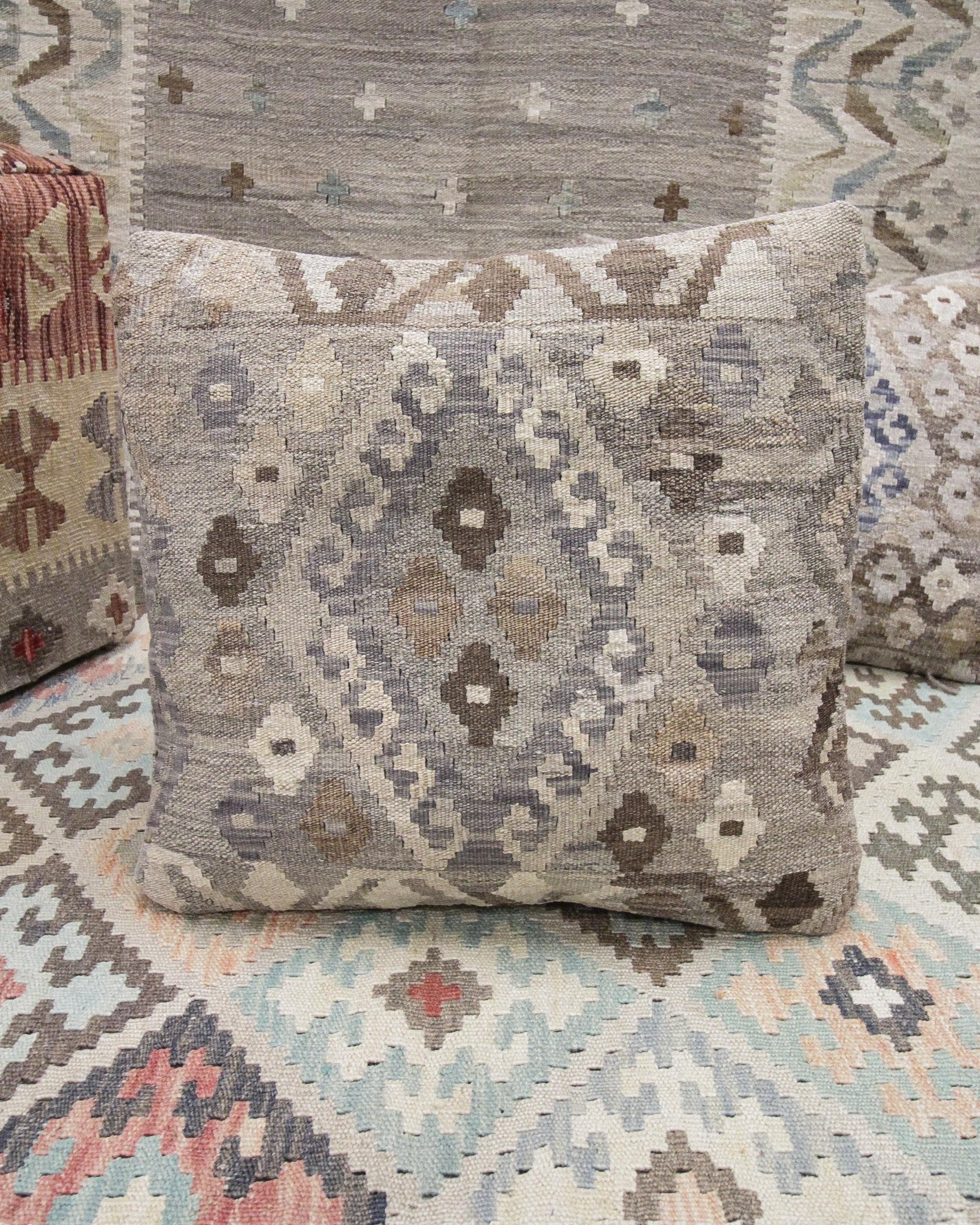 This new traditional kilim cushion cover is a handwoven piece constructed in the early 21st century. The design has been delicately woven by hand and features a symmetrical geometric pattern that is sure to stand out on any sofa or armchair! This