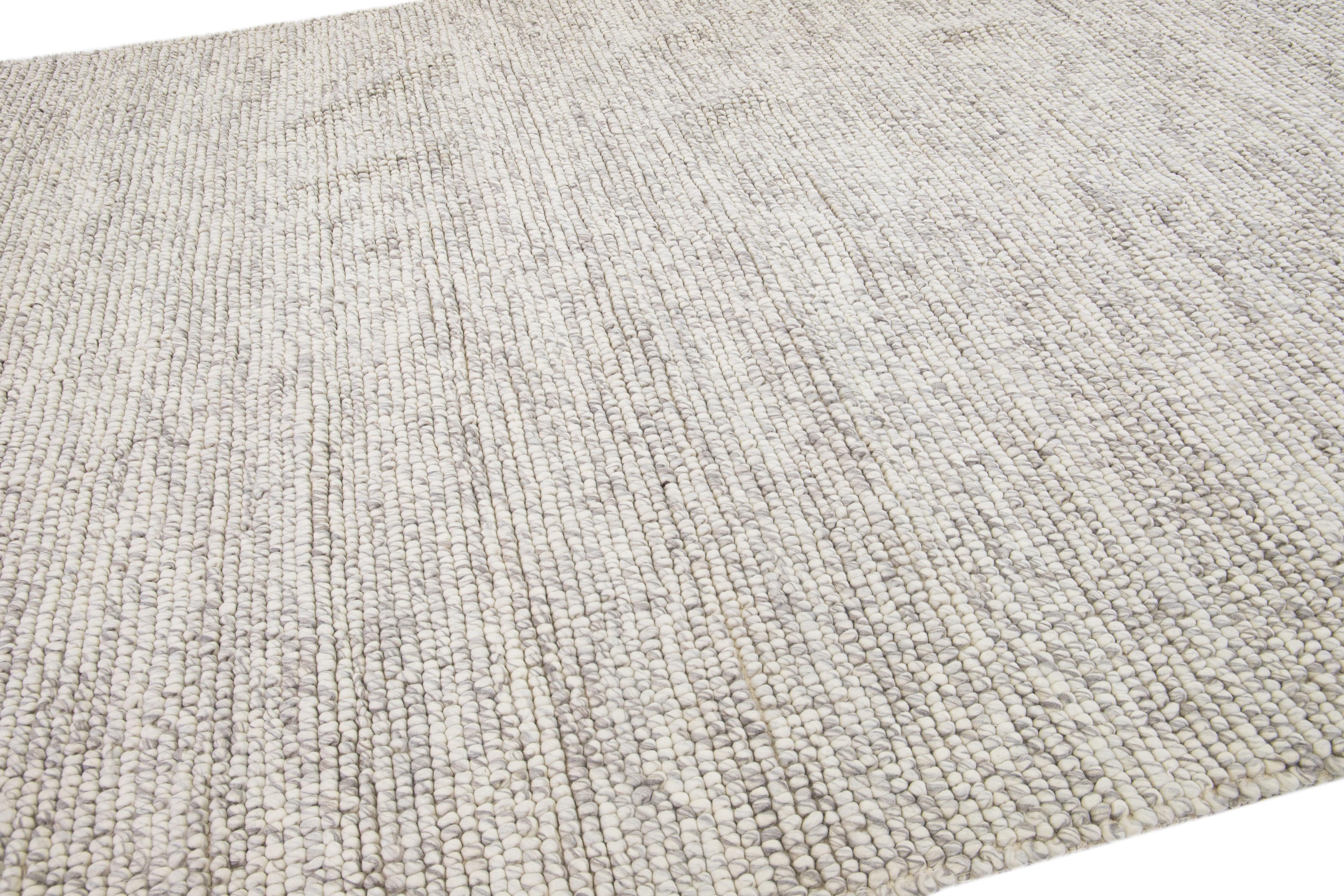 This beautiful Felt hand-woven wool rug is part of our Westport Collection with a beige color field and features an all-over geometric design.

This rug measures: 9' x 12'.

Custom colors and sizes are available upon request.

 