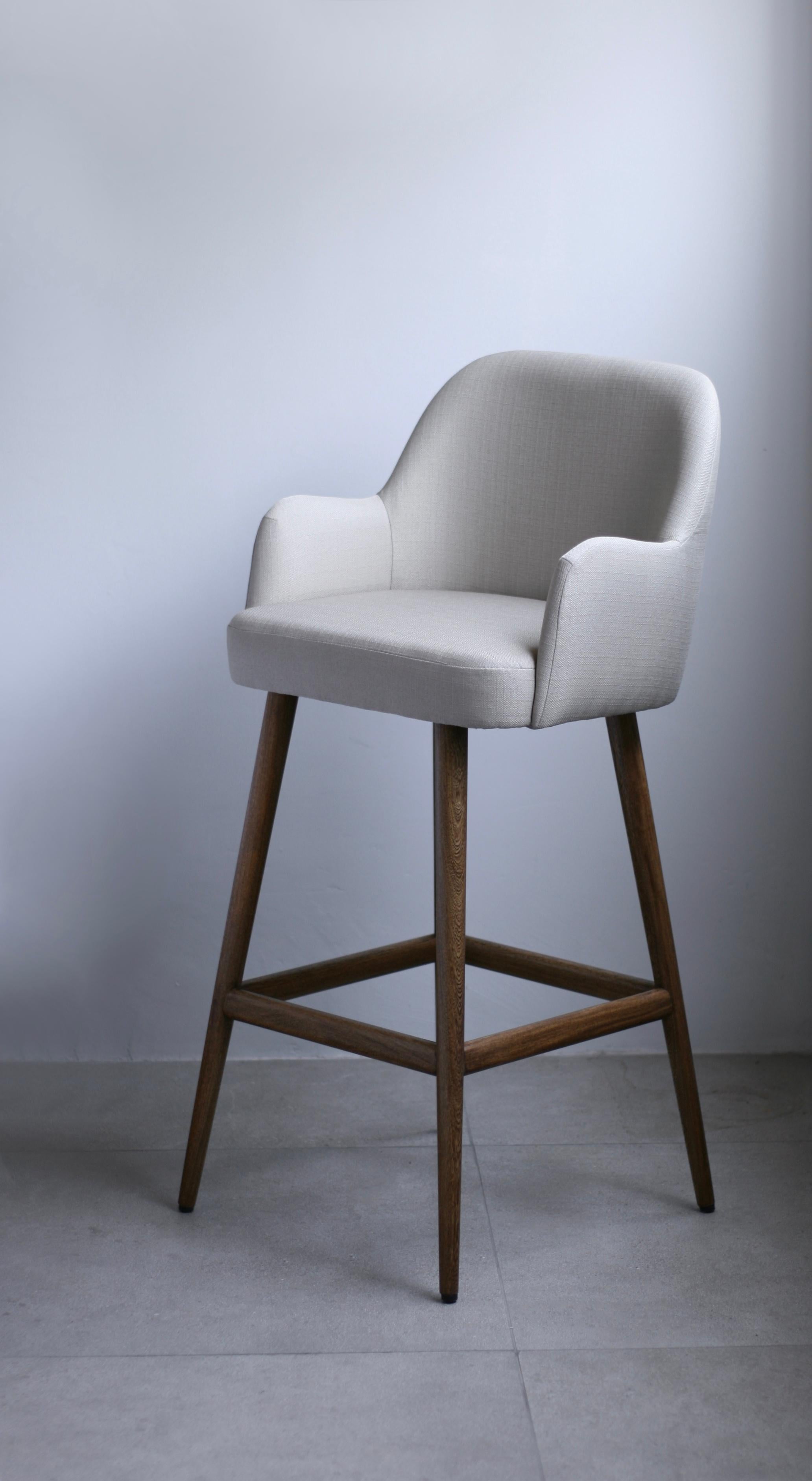 Helsinki collection. Helsinki bar arm stool: simple, elegant, comfortable. Available in oak and walnut base or in custom materials, may be upholstered with variety of fabrics and colors. Also available as a chair and stool. 

Our clients´ favorite