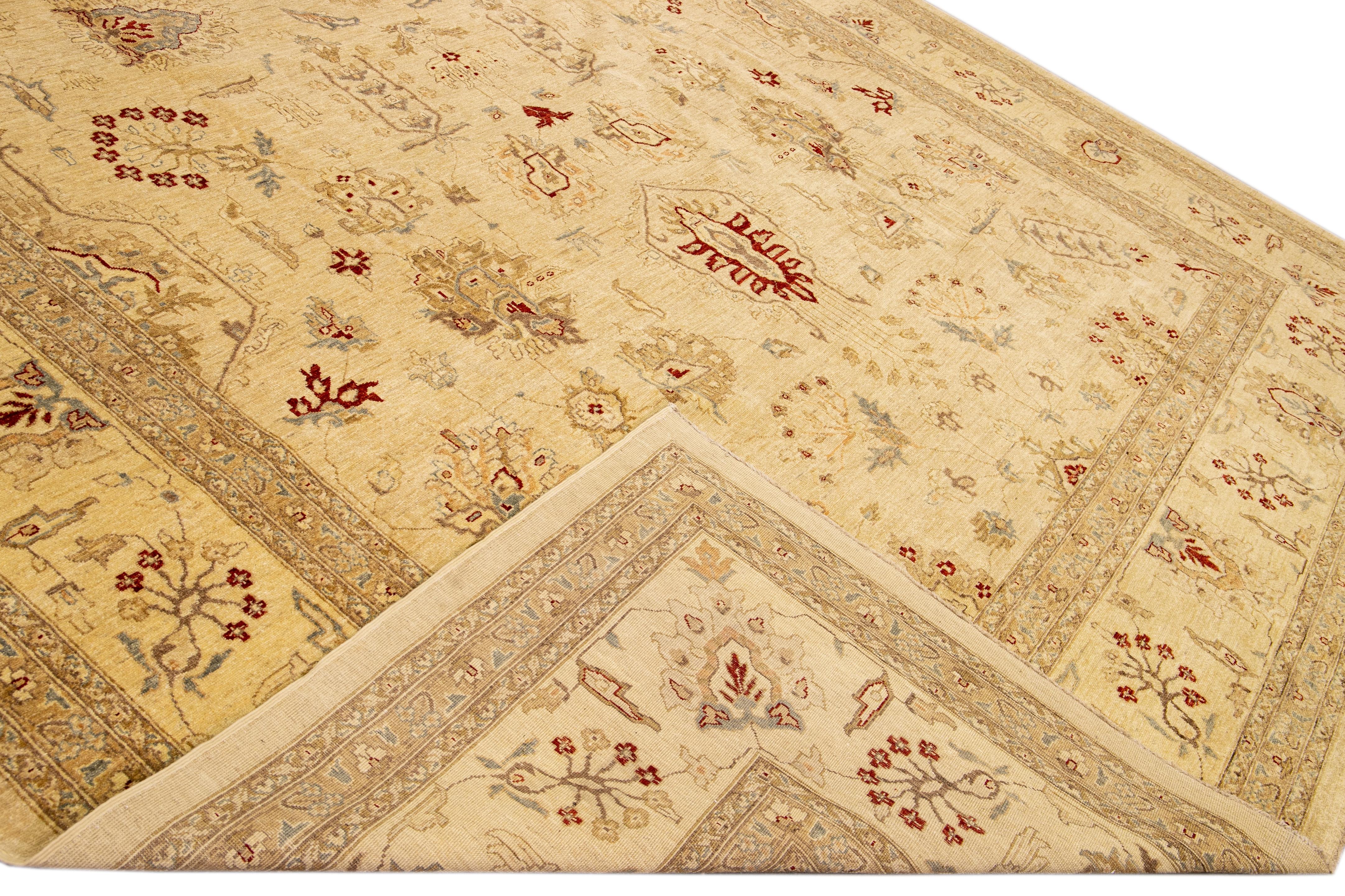 Beautiful Paki Peshawar hand-knotted wool rug with a beige field. This modern rug has a tan, red, and gray accents in a gorgeous all-over Classic vine scroll and a palmettes motif.

This rug measures: 11'11