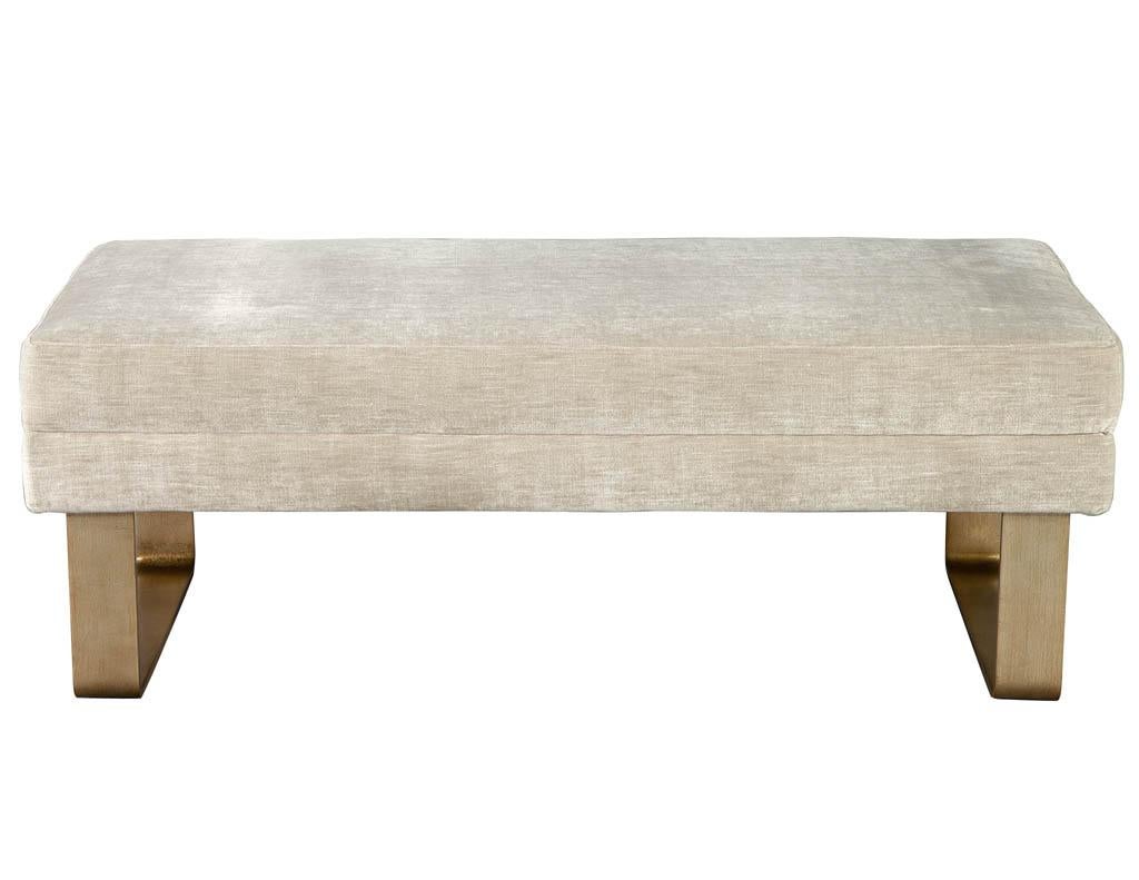 Modern bench with curved metal legs. Beautiful textured beige fabric with thick cushioning for maximum comfort. Completed with curved metal legs in an antiqued silver leaf finish with a light champagne color tone. America, circa 1970s, fully