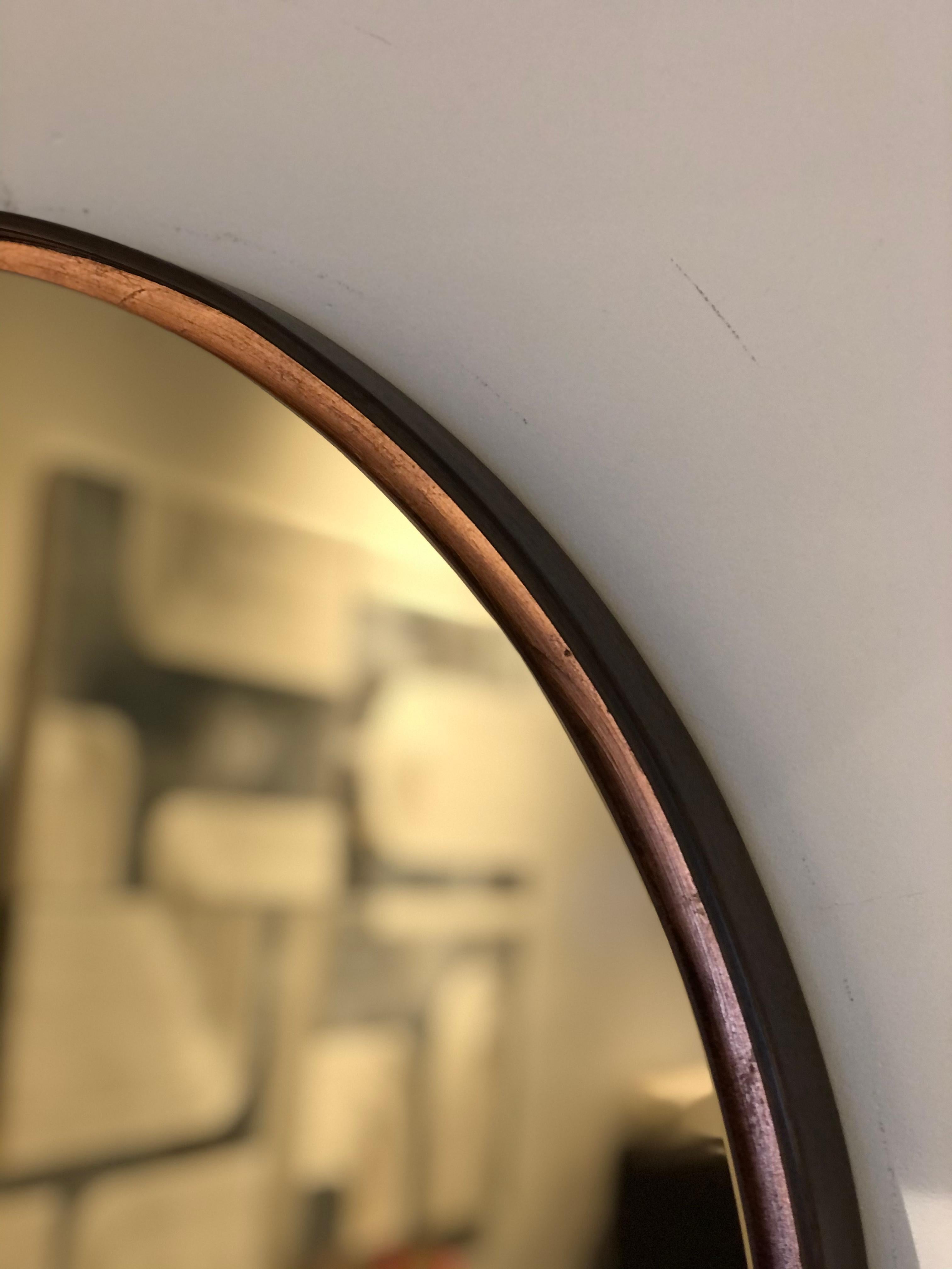 The process of wood steaming changes the cellular structure of wood to make it more pliable, once clamped to a form it takes it shape. The bronze mirror is set in to reveal a hand applied copper leaf finish between frame and mirror.

Sizing 27” W