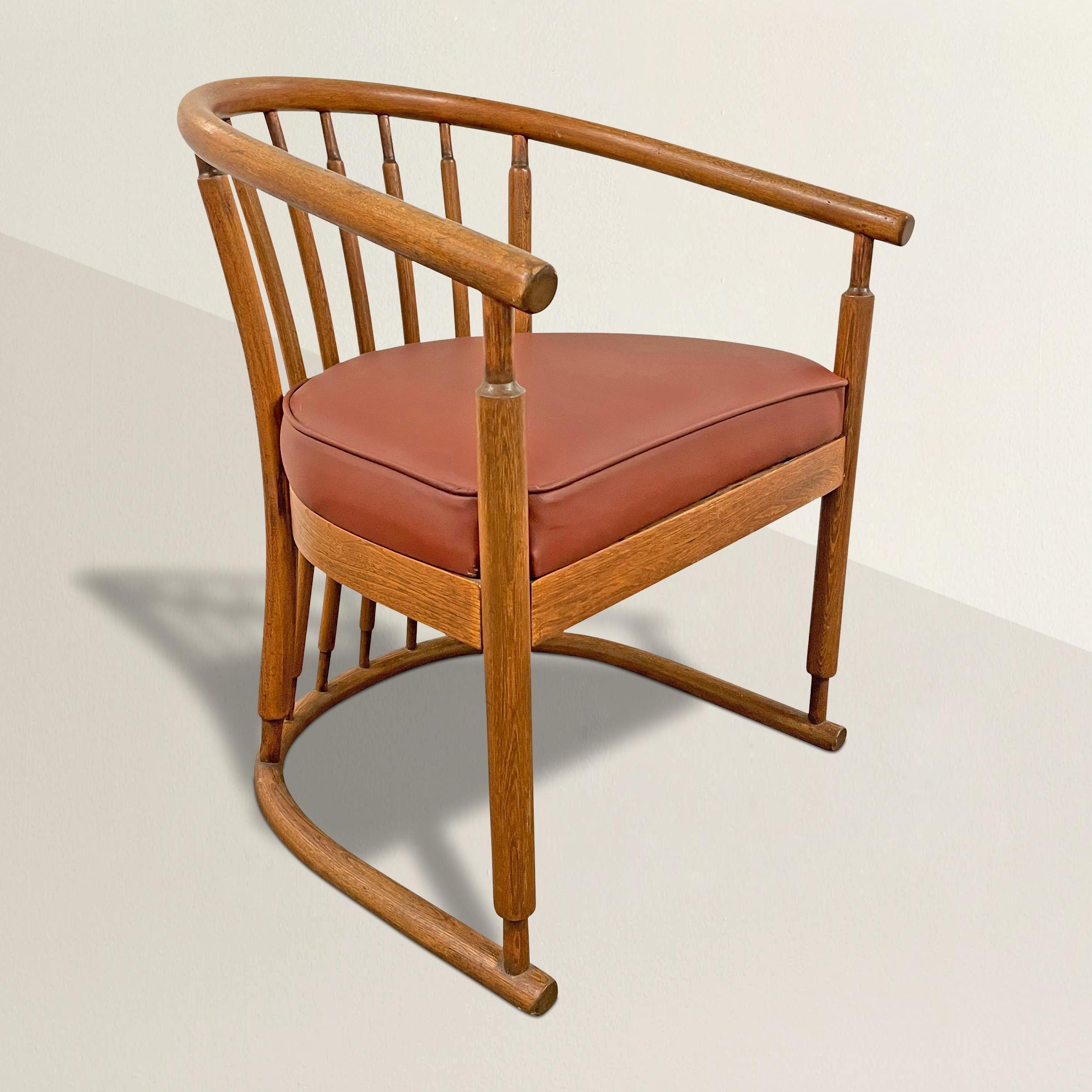 A chic modern bentwood barrellback arm chair constructed with a single bentwood horseshoe crestrail, a single bentwood horseshoe foot, and attached with several bentwood back spindles. The seat is newly upholstered in a soft red leather.