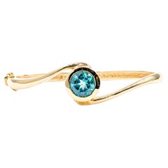 Modern Bezel Set Blue Topaz Hinge Bangle Bracelet in Yellow Gold