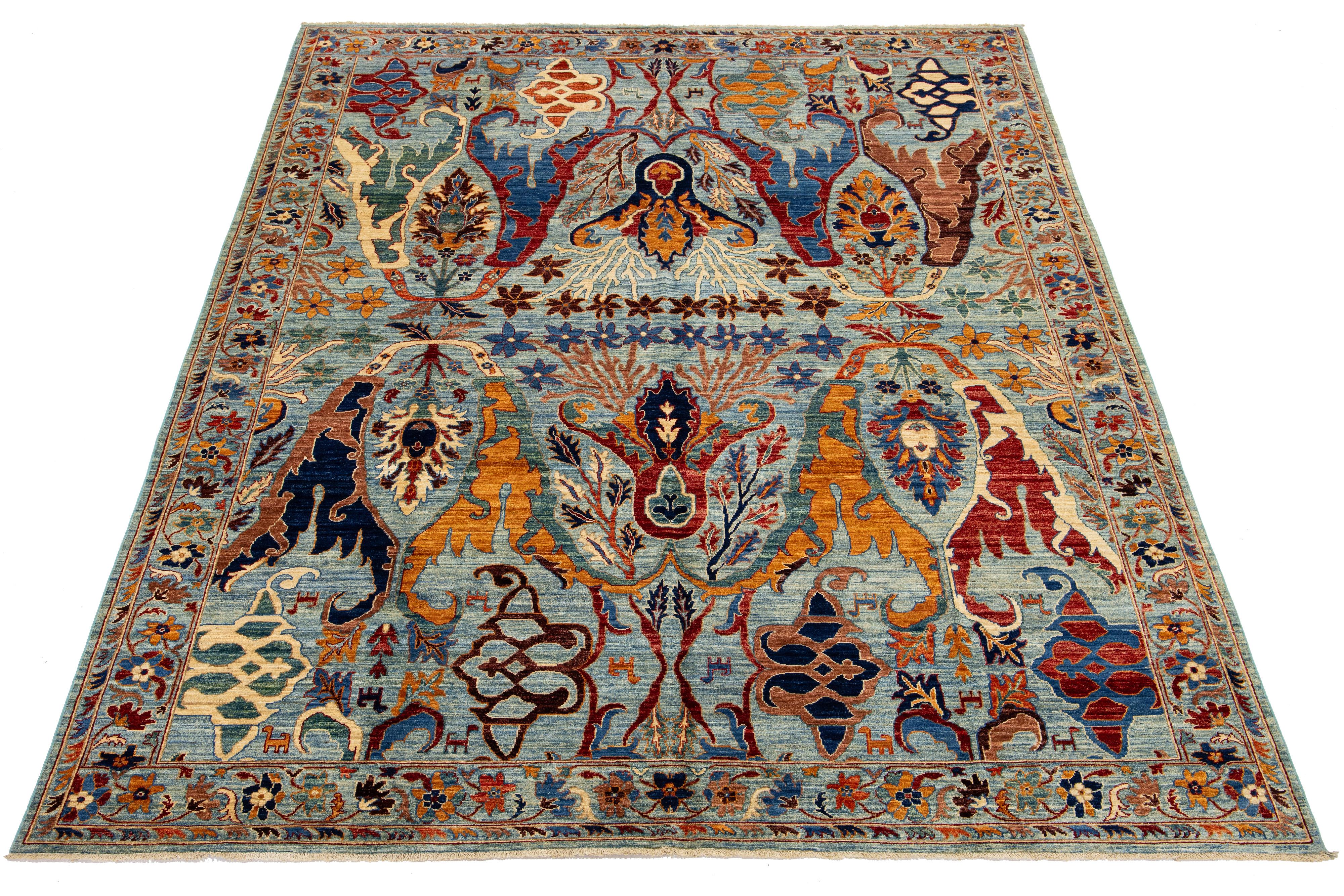 This beautiful hand-knotted wool rug displays a captivating Bidjar style with a tranquil blue background. Decorated with a gorgeous geometric floral design and enriched with various colors, it radiates contemporary charm.

This rug measures 8'11