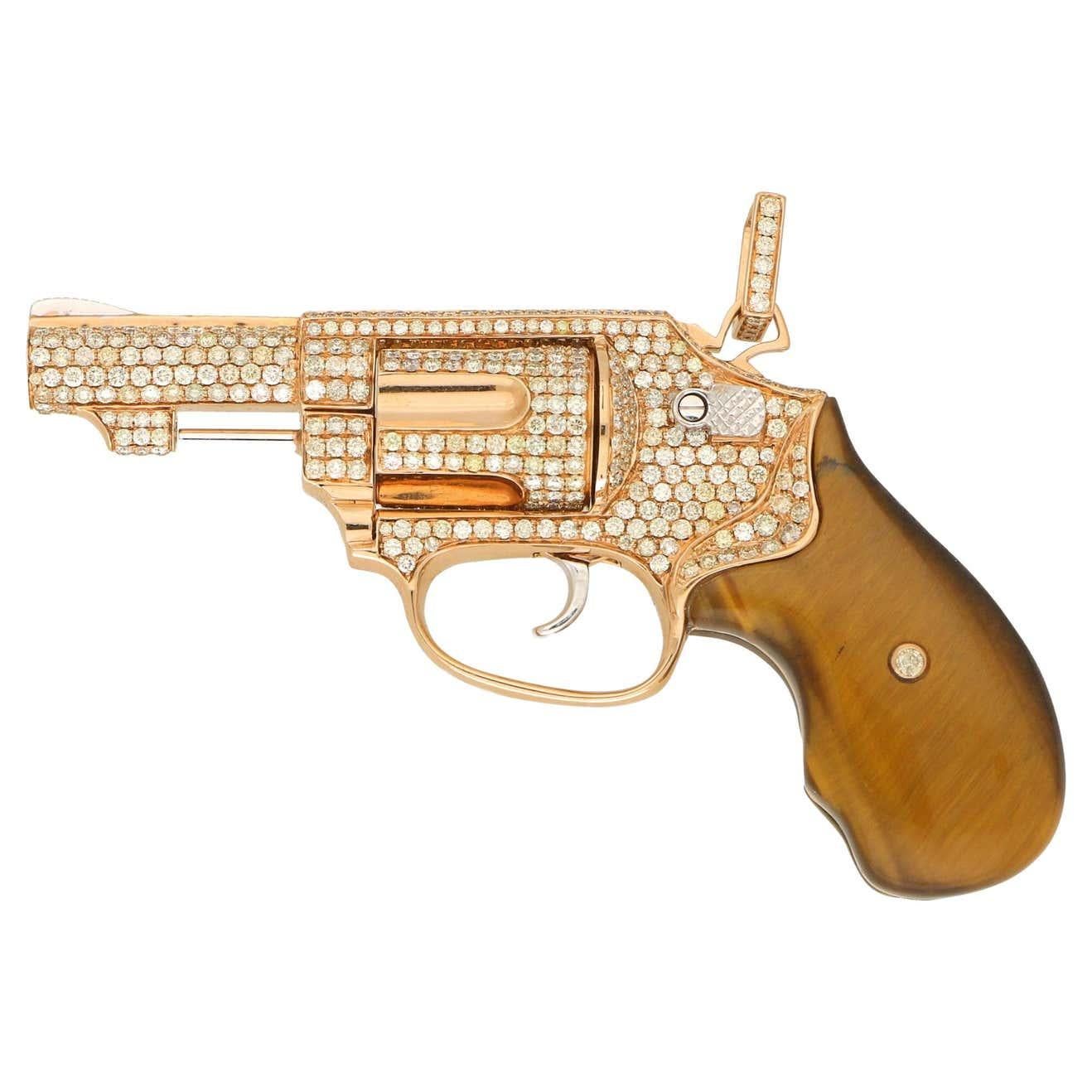 Diamond Gun Revolver Tiger's Eye Gem 18 Karat Rose Gold Giant Necklace Pendant
18 Karat Gold
Genuine Tiger’s Eye Stone & Natural Diamonds 13.50 CTW
Approximate Mini Peacemaker Length: 7.85” inches / 20 centimeters / Gross Weight: 75g

Made to Order