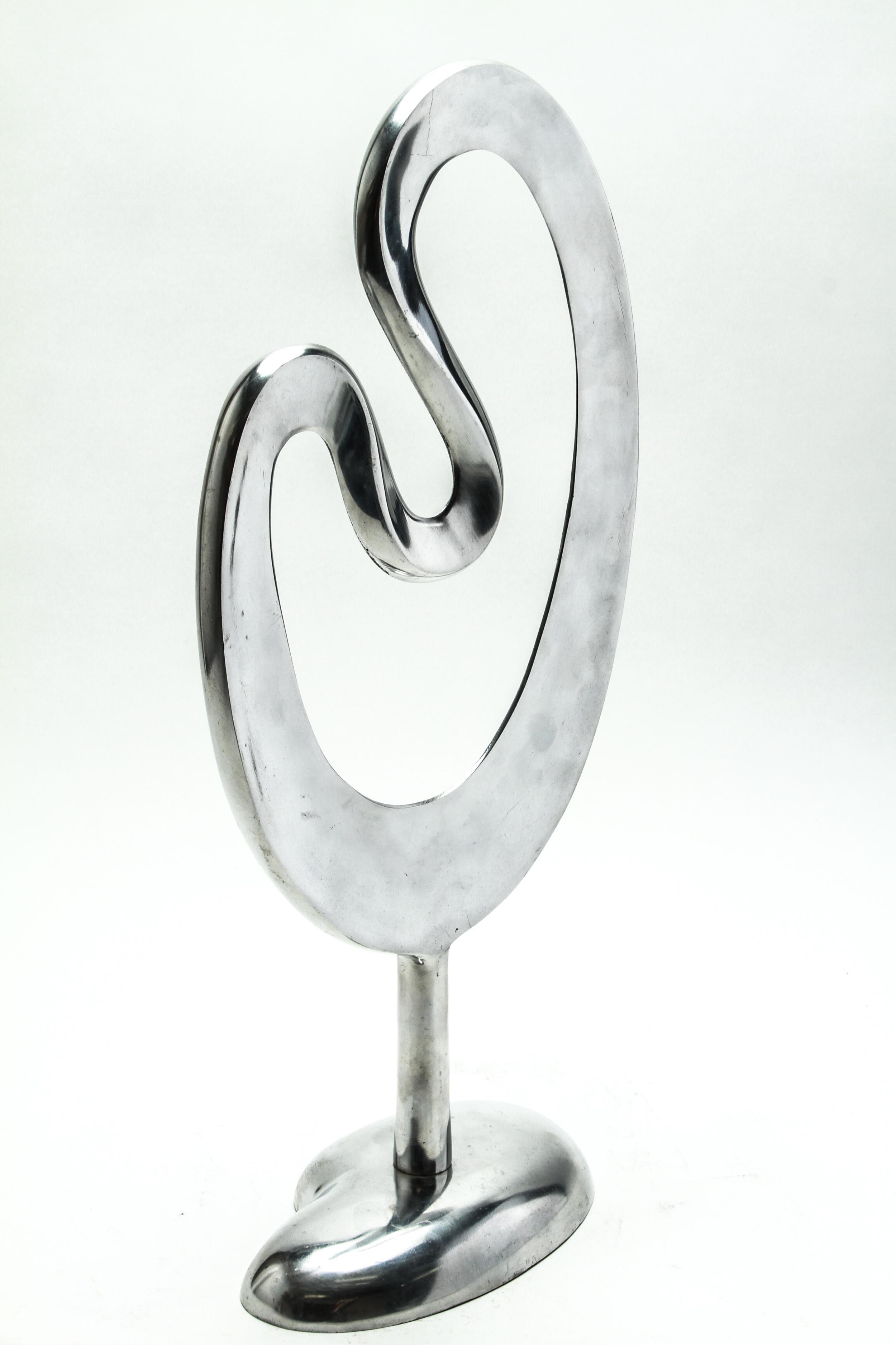 Modernist chromed aluminum biomorphic tabletop sculpture, in an undulating pierced form atop a columnar base and an oval foot. The piece is in great vintage condition with some minor age-appropriate wear.