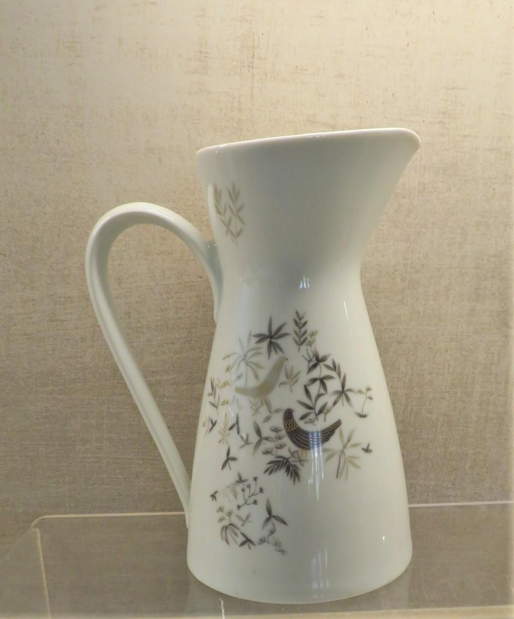 A rare find, a water pitcher in this exquisite pattern Birds on Trees by Raymond Loewy for Rosenthal, Germany. Birds on Trees was only produced from 1961- 1964. Elegant and modern depiction of birds resting on some stylized trees done in a palette