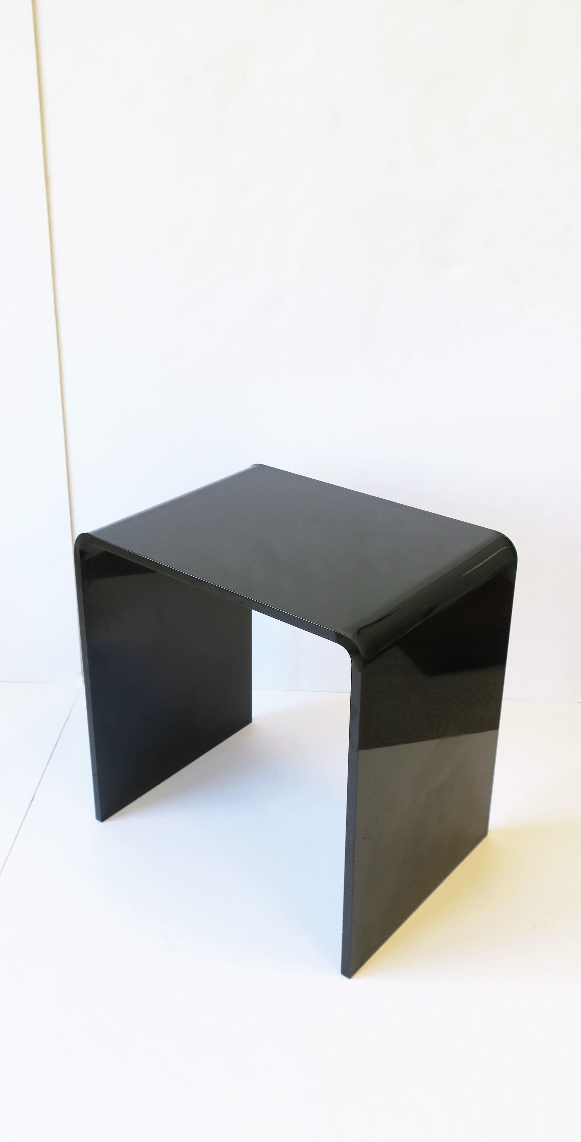 A jet-black acrylic modern style side or end table with 'waterfall' edge, circa early-21st century. Piece measures: 12