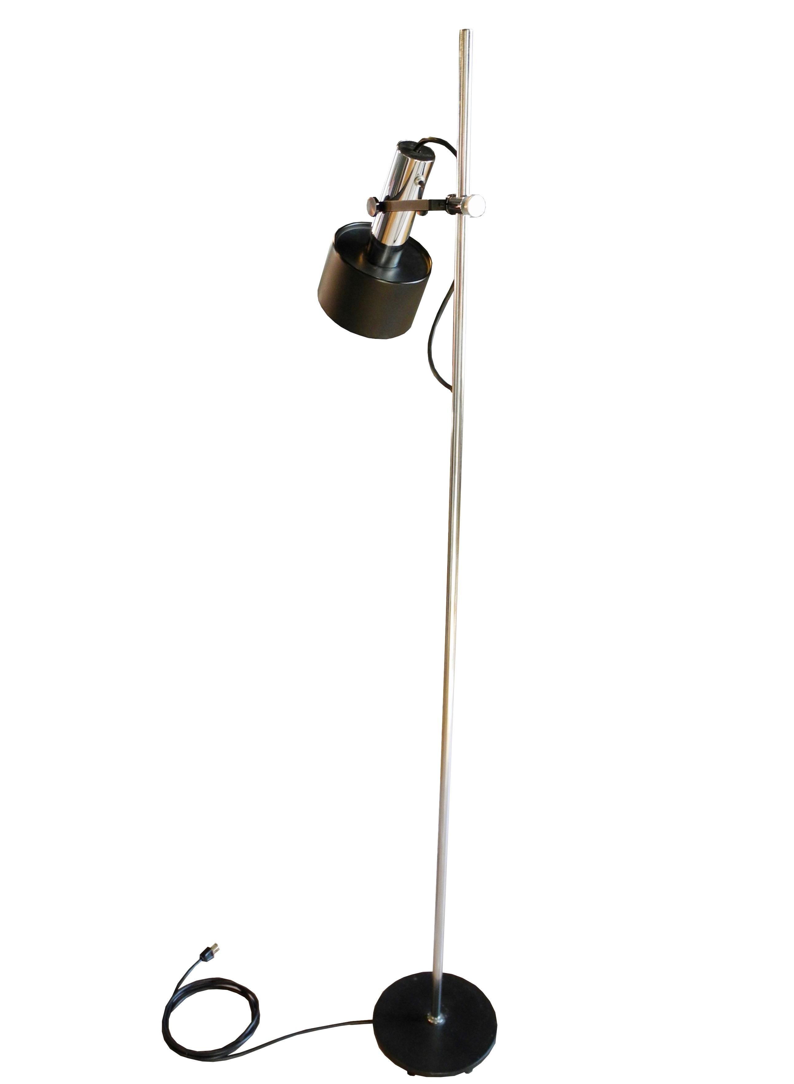 This modern adjustable versatile floor lamp goes up and down the rod and swivels all around on the arm. The lamp has a weighted iron base and works perfectly.