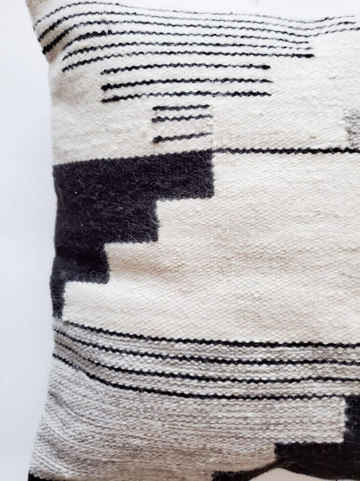 Product information
Material: Natural Wool 
The back is a fabric with a hidden zipper 
Handwoven on a pedal loom
Insert is not included 

Colour:
Cream 
Black
Gray
 