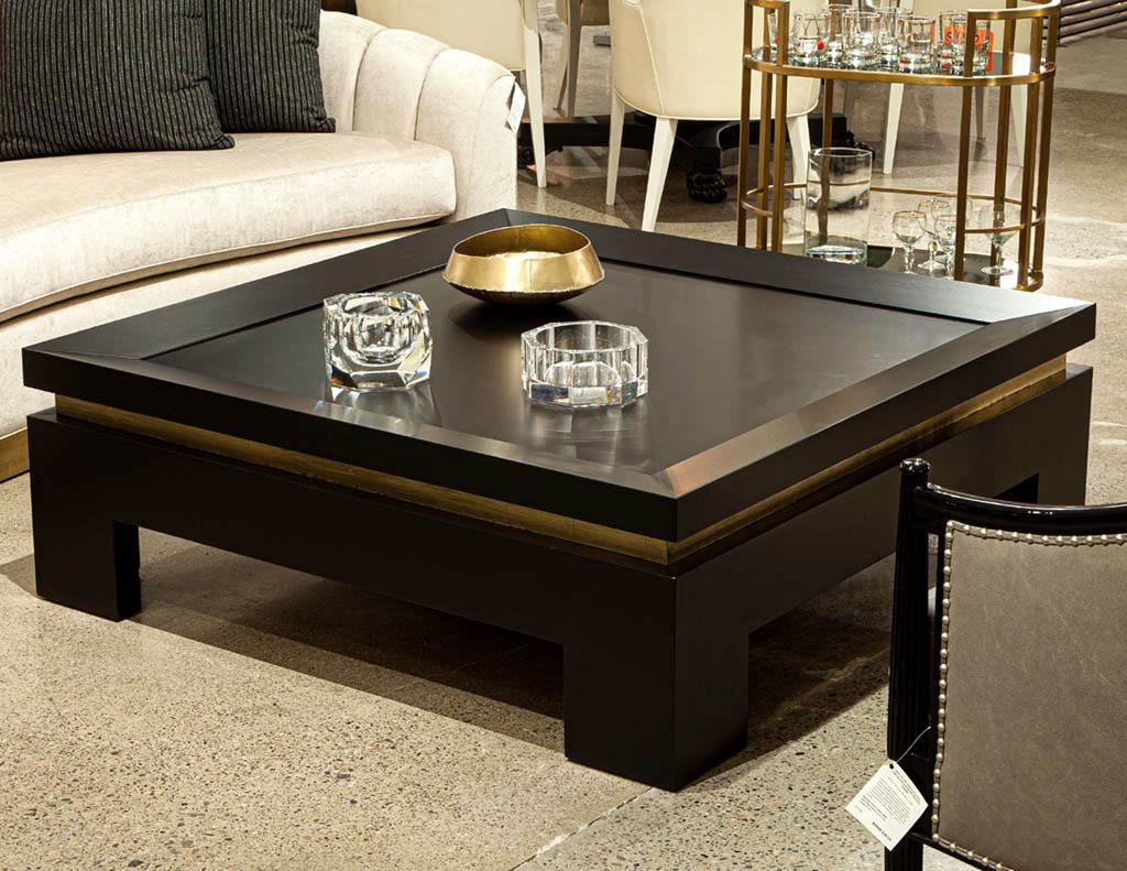 Modern black and gold square coffee table. Solid wood construction, made in the USA. Simplistic, modern, and elegant. Custom finished in a satin black lacquer with antiqued gold accenting. Top features unique tapered edge with large surface area,