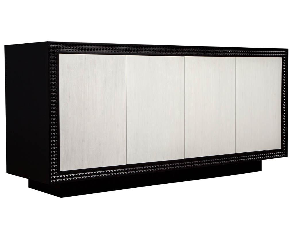 Modern black and white buffet sideboard. With white lacquered door fronts and black exterior finish. Front edge features unique textured trim detail.

Price includes complimentary curb side delivery to the continental USA.