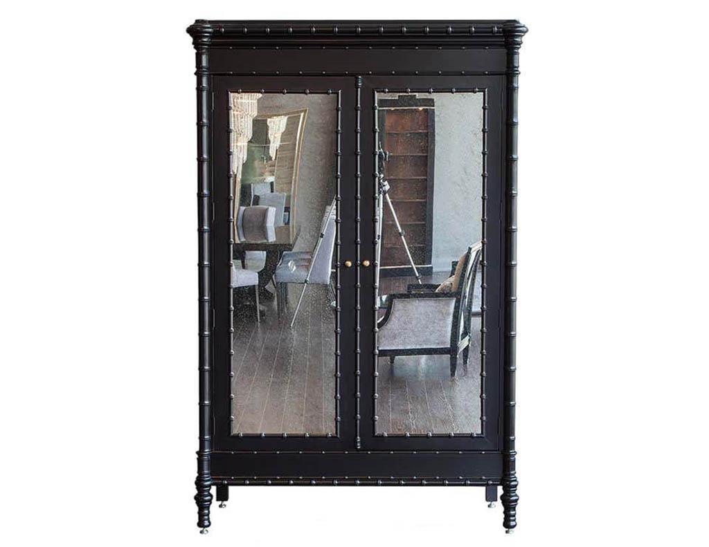 Modern black armoire cabinet in faux bamboo. Designed by Julia Gray faux bamboo armoire entertainment cabinet. Finished in a Classic black satin lacquer with faux bamboo appointments this armoire complements a traditional or modern setting. With