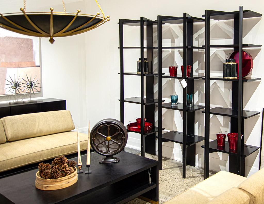 The Modern Black Bookcase Shelving Cabinet. This stunning piece is proudly made in the USA and boasts a sleek satin black lacquer finish that adds a touch of elegance to any room. The unique modern design of this bookcase is sure to make a statement