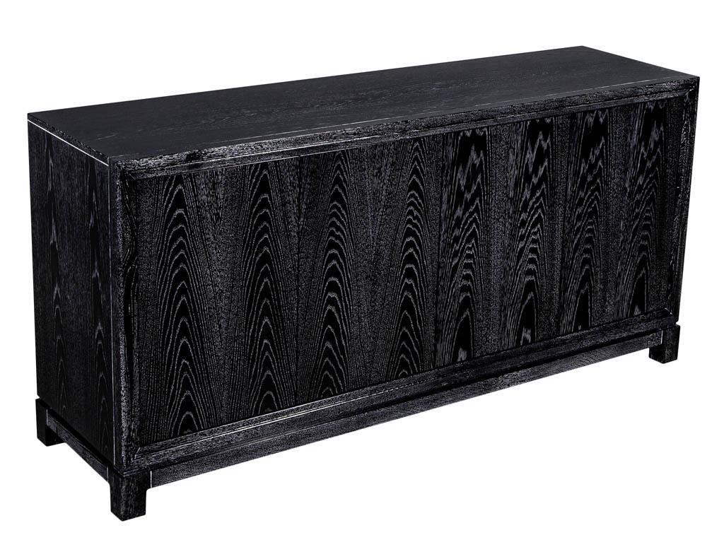 Modern black cerused oak sideboard buffet. Featuring a dark ebonized black ceruse finish with contrasting white grains. Doors open with sleek push touch latches, height adjustable shelves and hideaway center drawer.

Price includes complimentary