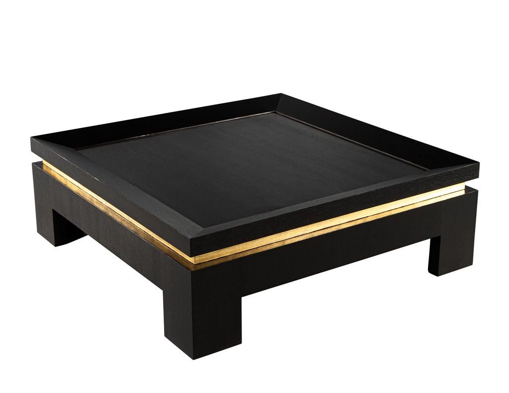 Modern Black Coffee Table with Gold Leaf Accents. Solid wood construction, made in the USA. Simplistic, modern, and elegant. Custom finished in a satin black lacquer cerused technique with antiqued gold accenting. The ceruse finish allows for the