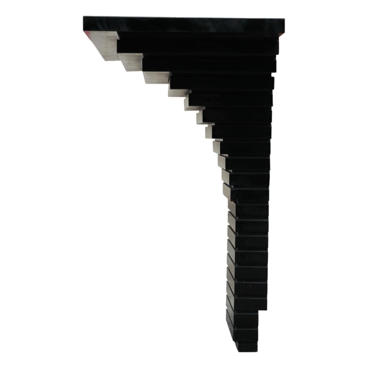 Modern black console entry way table with a layered geometric shape. The paint is a high gloss black and can be redone for an additional cost.