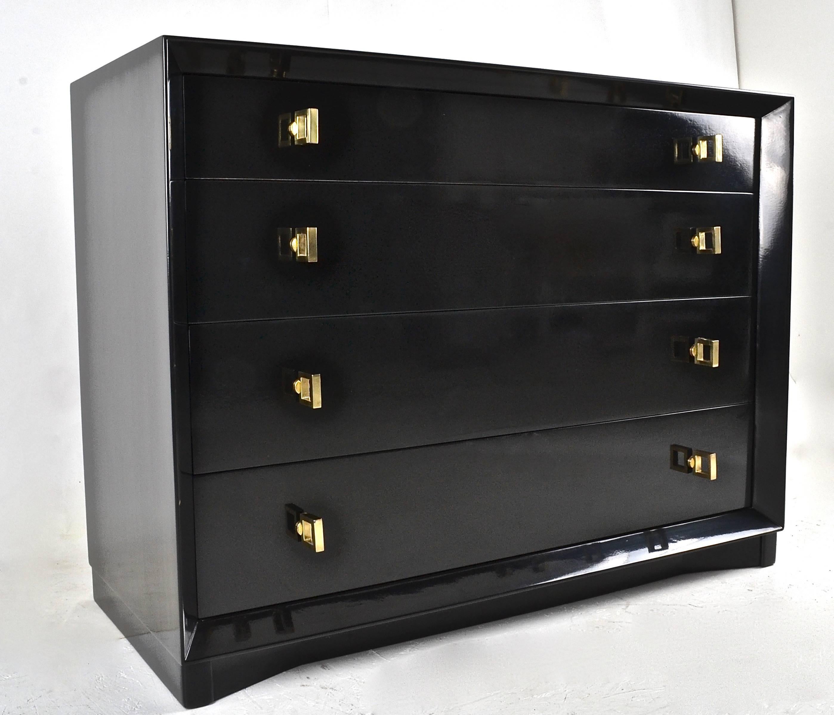 Newly finished in high gloss black lacquer, a Classic form early modern chest with four drawers. Original brass finish pulls have been polished and lacquered. Quality construction --all wood.