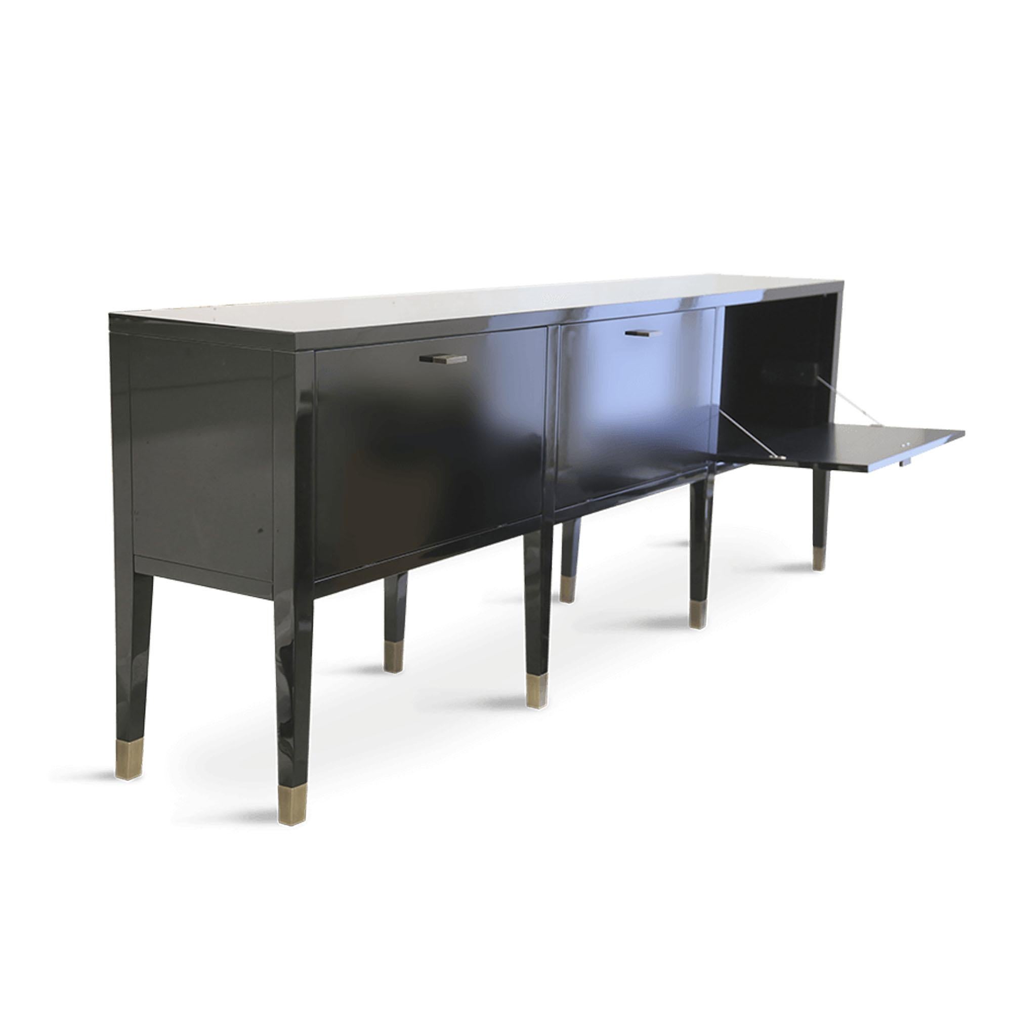 Elegant and fabulous, the sideboard is a stylish addition to the room. The black piano finish cabinet has a deeply luxurious appearance. With storage compartments behind three doors, this furniture piece is elegantly decorated with burnished solid