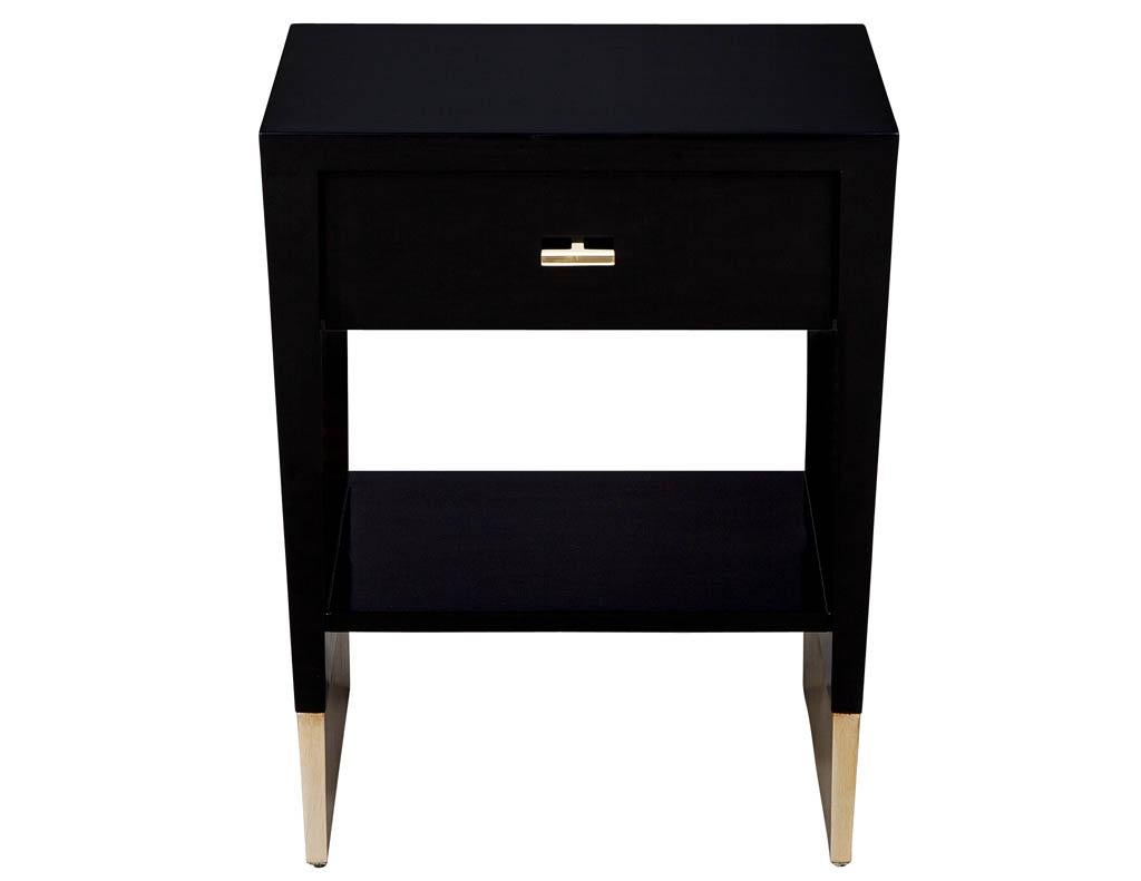 Modern black lacquer end table Rachmaninov by Jacques Garcia Baker. Sleek modern design in hand polished black. Featuring sleek hardware and metal leaf foot accent.

Price includes complimentary curb side delivery to the continental USA.