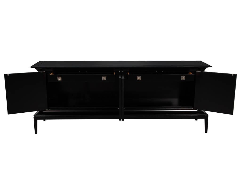Modern black Lacquered sideboard credenza with Faux Parchment fronts. Featuring unique shaped design with ample storage options. Completed with a beautiful black lacquered finish and faux parchment doors.

Price includes complimentary curb side