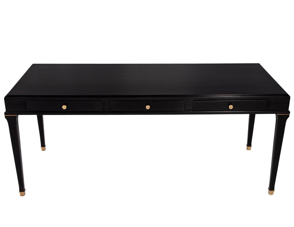 Introducing the perfect addition to your home office or study - the Modern black lacquered writing desk. With its clean and minimalist design, this desk exudes a sleek and contemporary vibe that will elevate any space. The glossy black lacquered