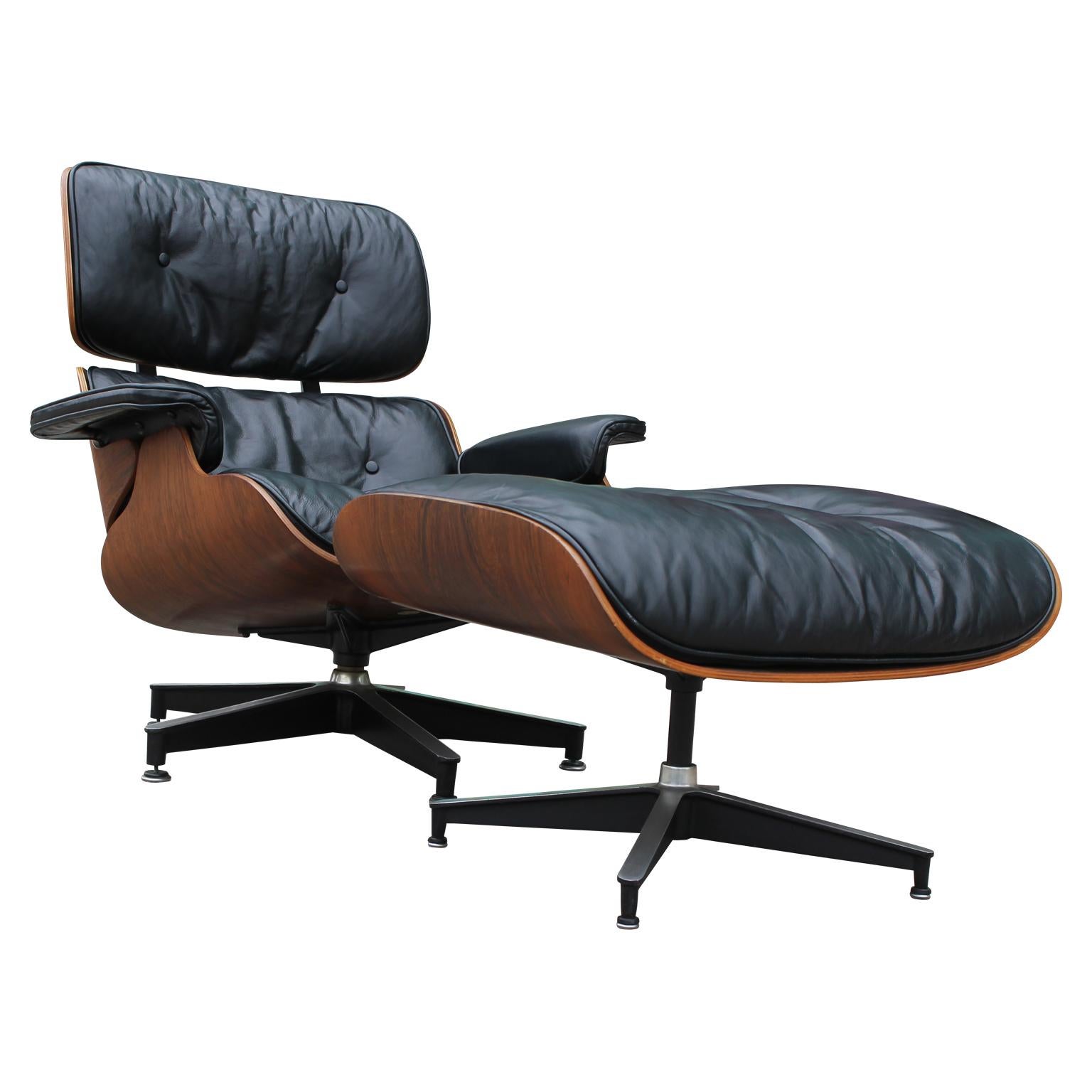 Lovely modern black leather and rosewood Eames lounge chair and ottoman for Herman Miller.

Dimensions of ottoman: 25.5 in W x 22 in D x 17.5 in H.