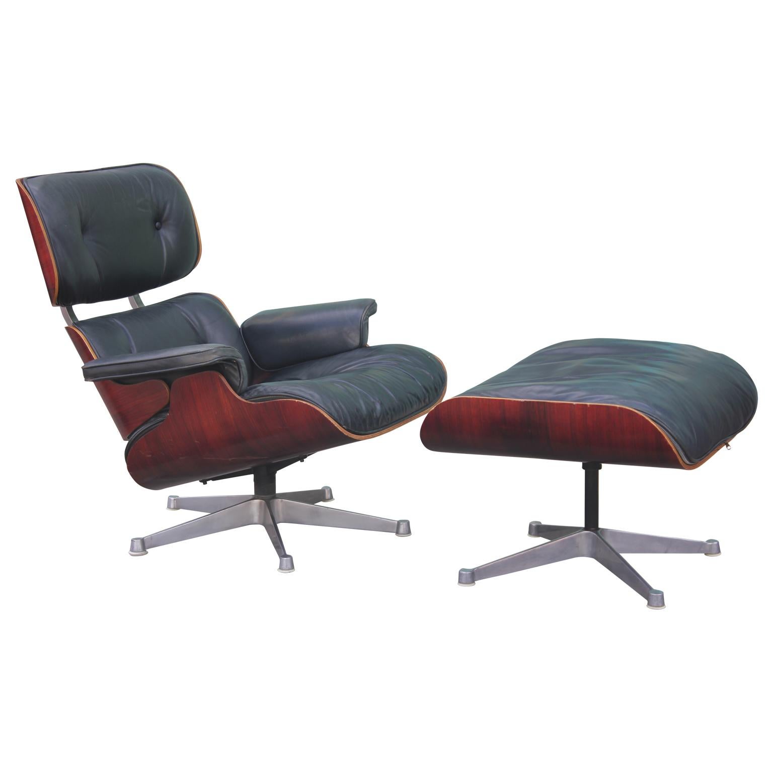 Lovely modern black leather and rosewood lounge chair and ottoman designed by Vitra and Eames for Herman Miller. 

Dimensions of ottoman: 25.5 in. W x 22 in. D x 17.5 in. H.