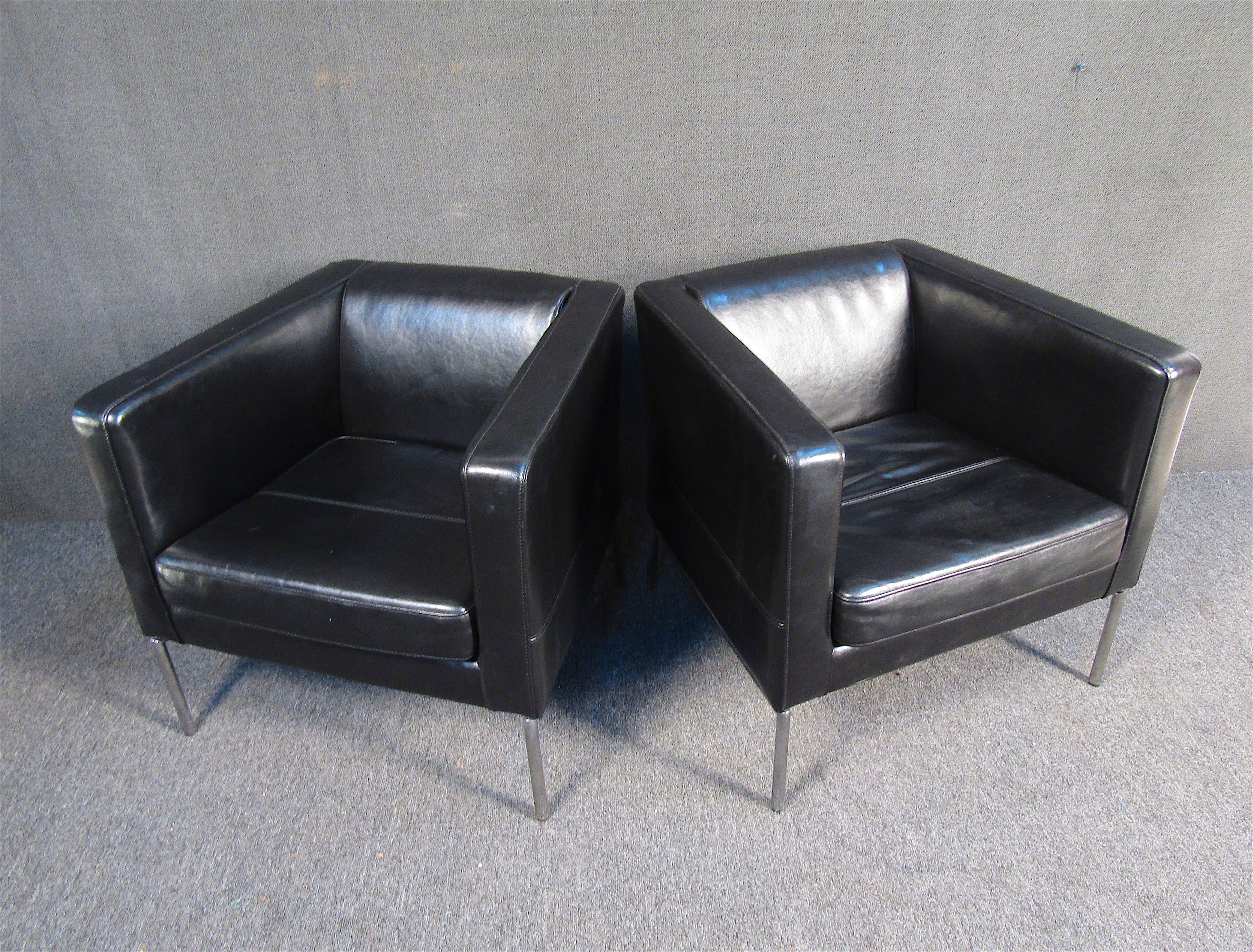 A sleek pair of black leather club chairs. The chairs are upholstered in supple black leather with metal legs. These chairs would be a great addition to any living or lounge area.

Please confirm item location with seller (NY/NJ).