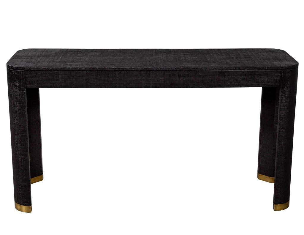Modern black linen clad console table. Featuring clean modern design and brass capped feet.

Price includes complimentary curb side delivery to the continental USA.