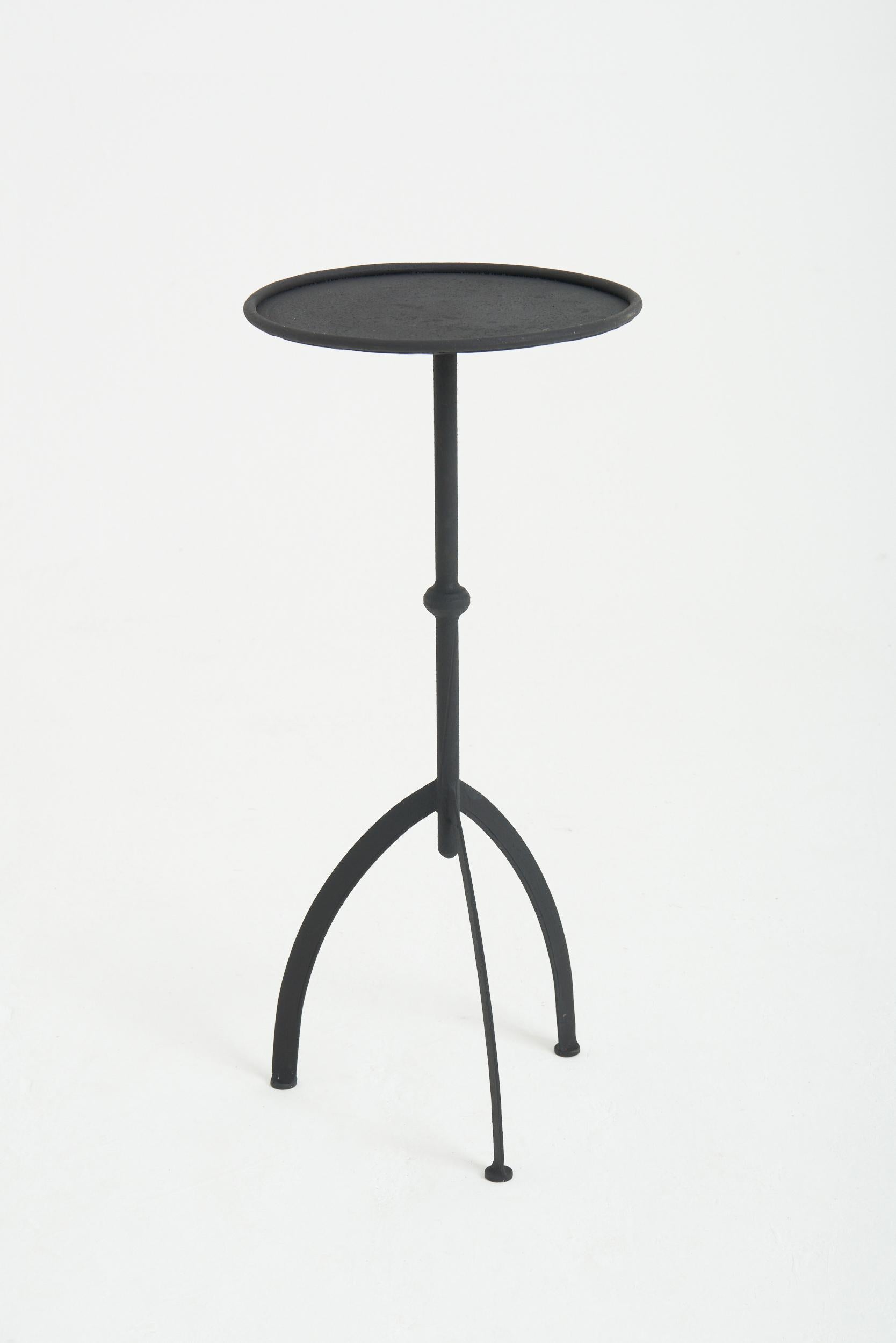 A black patinated wrought iron martini table
Spain, contemporary
60.5 cm high by 27 cm diameter