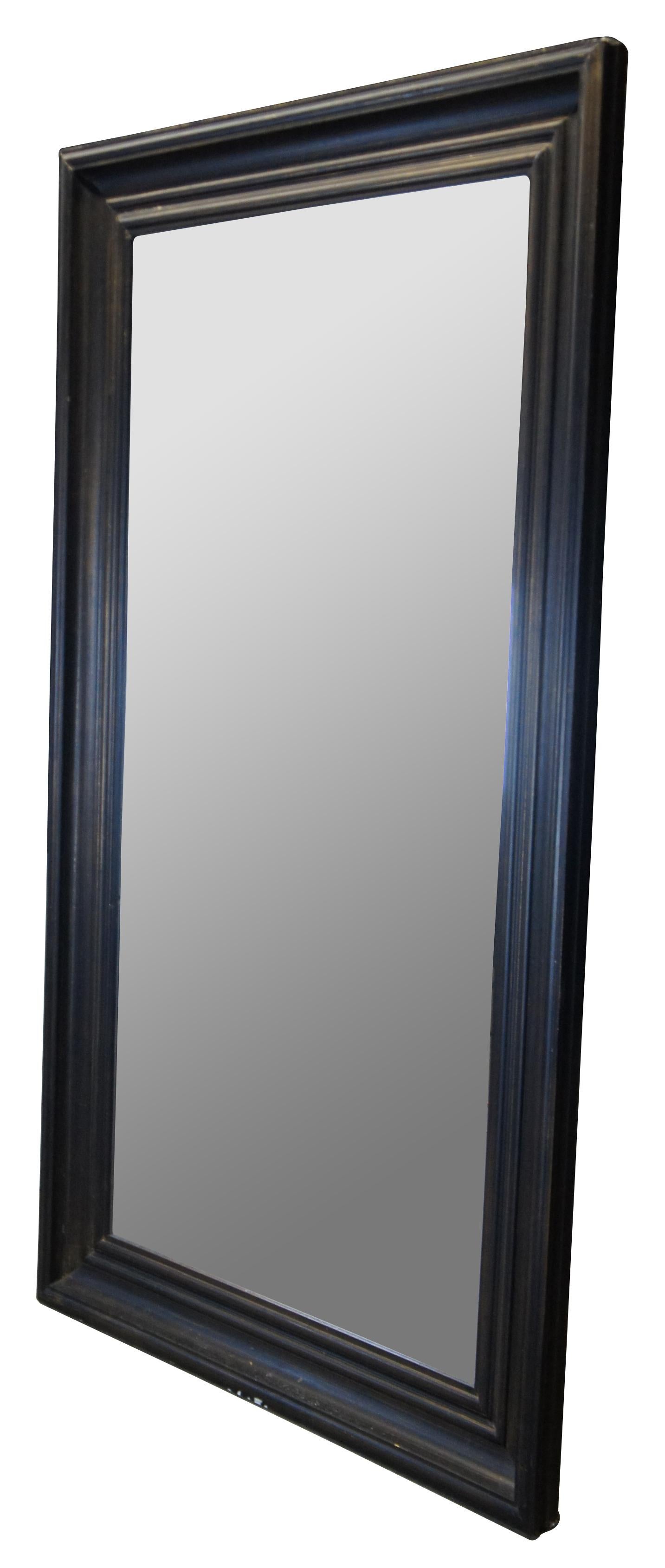 Oversized modern wall mirror. Great for use in freestanding setting, or over a mantel/ along a wall. Black over gold rubbed finish with beveled glass. Measures: 48