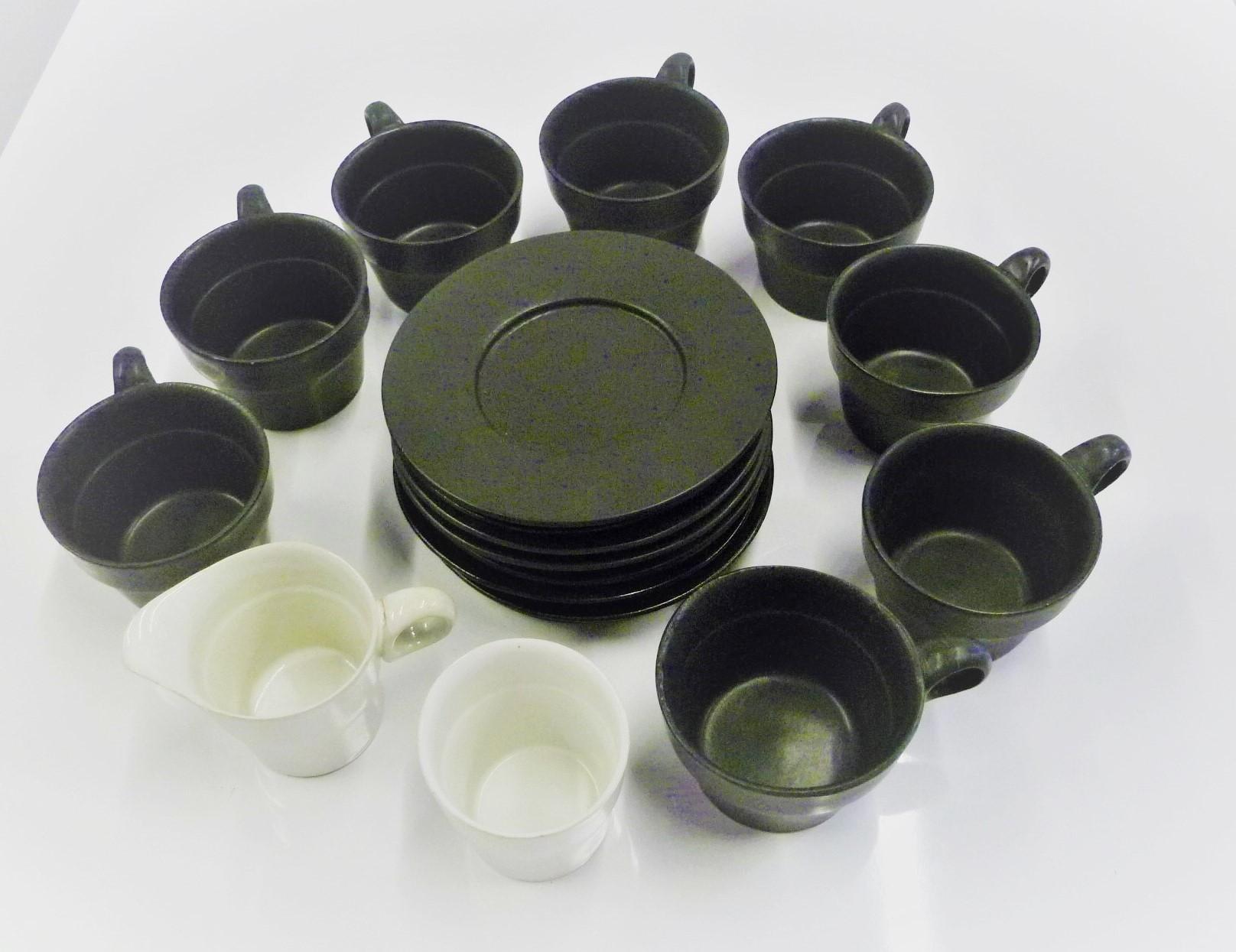 Designed by David Gil (1922-2002) for his company Bennington Potters of Vermont, a set of 8 Matte black cups #1760 and saucers #1627 and Matte white sugar #1769 and creamer #1768. These are handmade stoneware pieces from the 1960s, each an