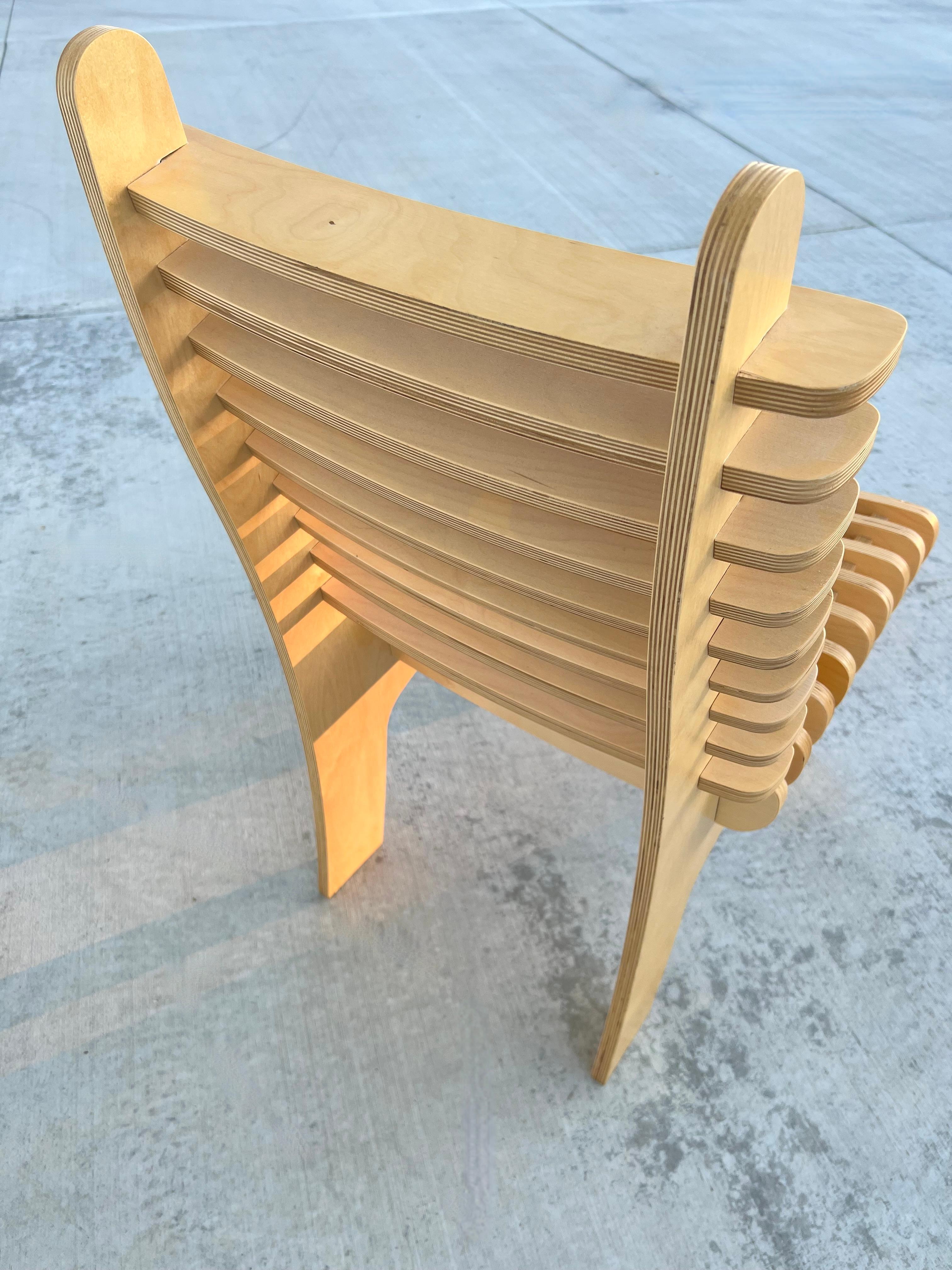 Chair as art.  This modern sculptural slatted chair is made with plywood & finished with natural tung oil.  It has no nuts, bolts, glue or screws. Each slat fits snuggly inside one another and is surprising comfortable and fully functional. It has