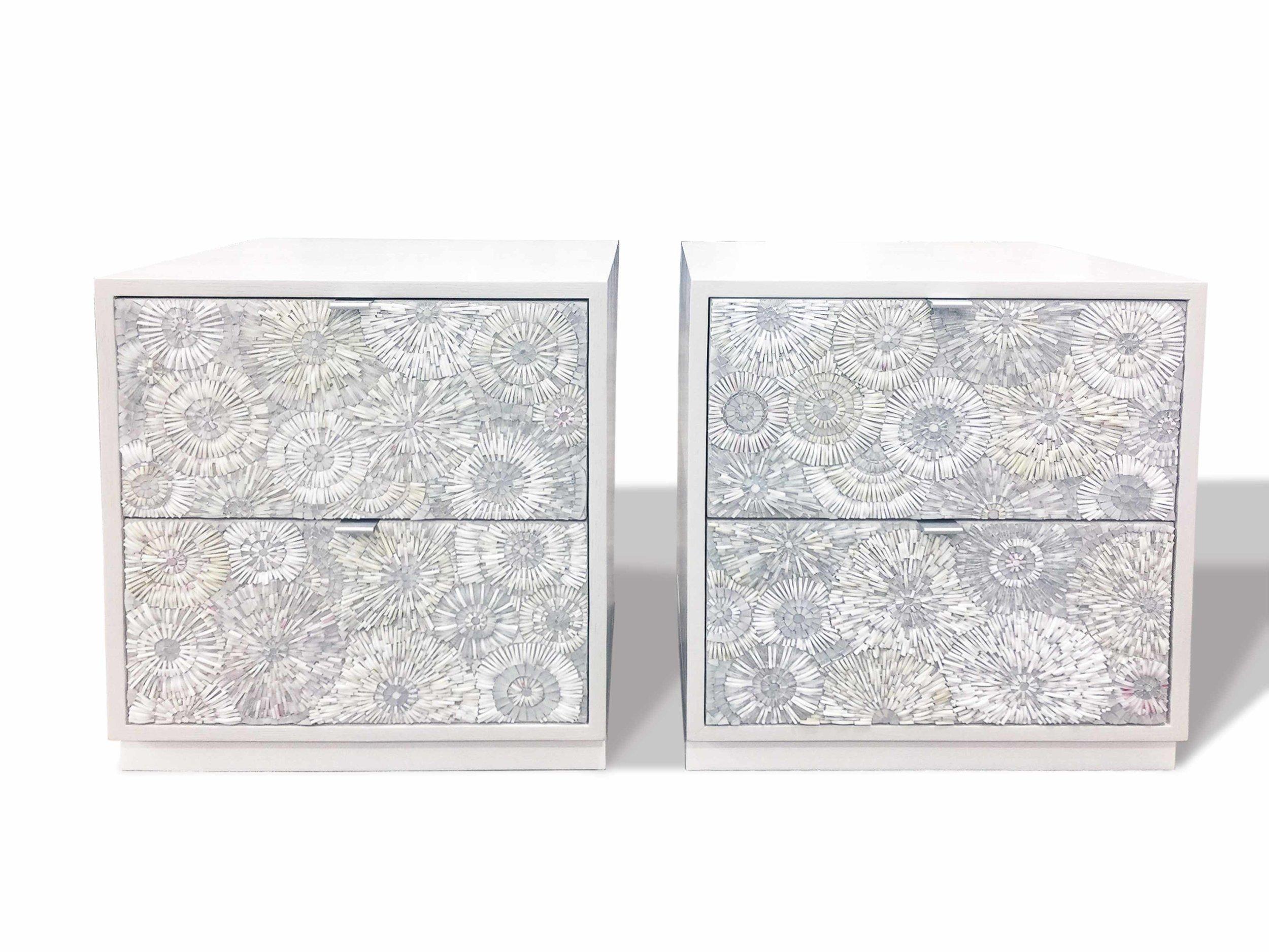The Blossom 2-drawer Platform nightstand by Ercole Home is a two drawer bed side table, raised on a platform base. The case of this nightstand is has a Painted White finish on Oak, and the drawers are adorned in our hand-cut blossom mosaic with