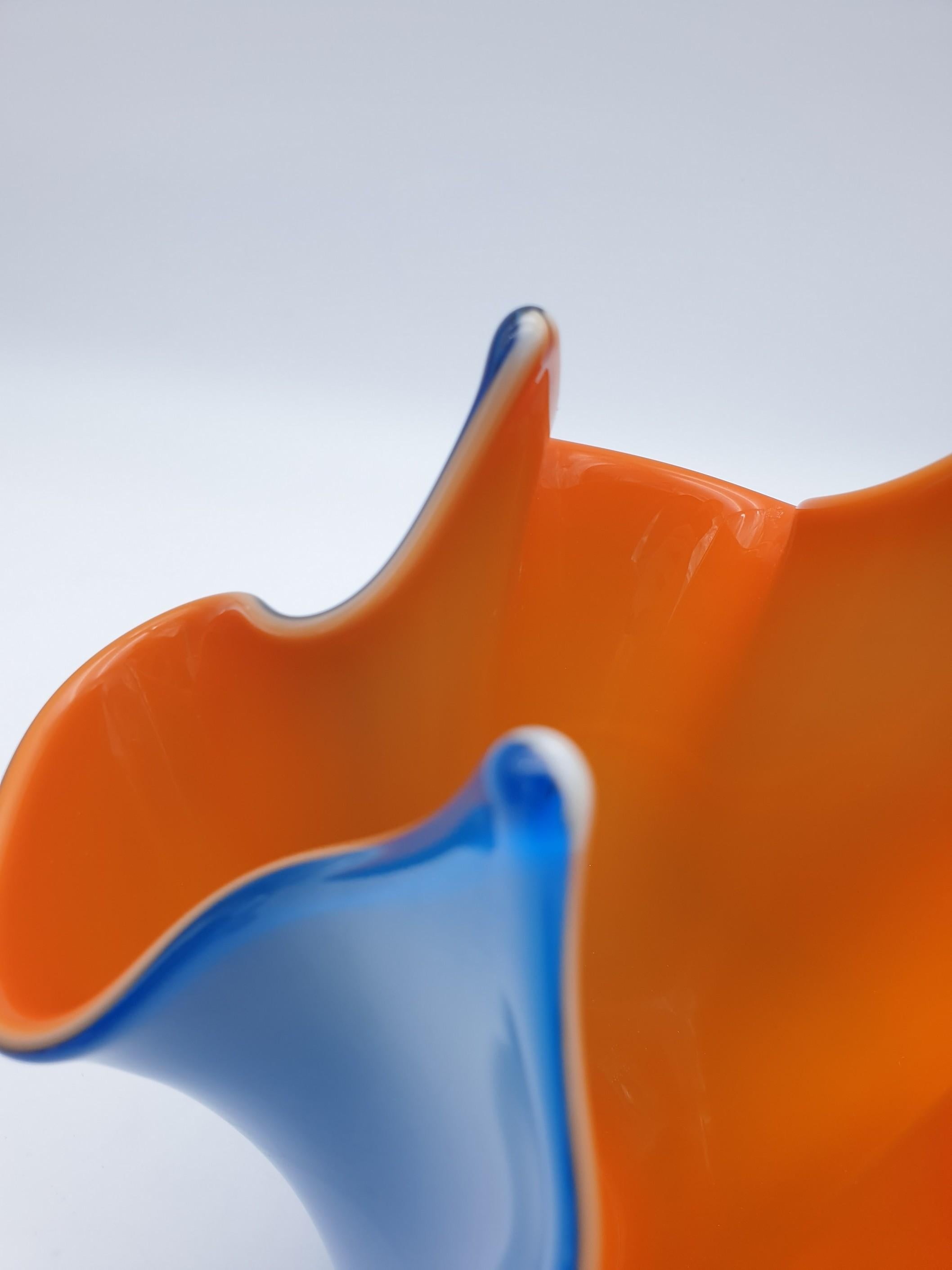 This modern, colorful vase has been manufactured in Murano by the Gino Cenedese e Figlio glass-factory in the 1980s, using the 'incamicato' technique. 'Incamiciato' glass is composed of one or more cased layers: generally, colored transparent glass,