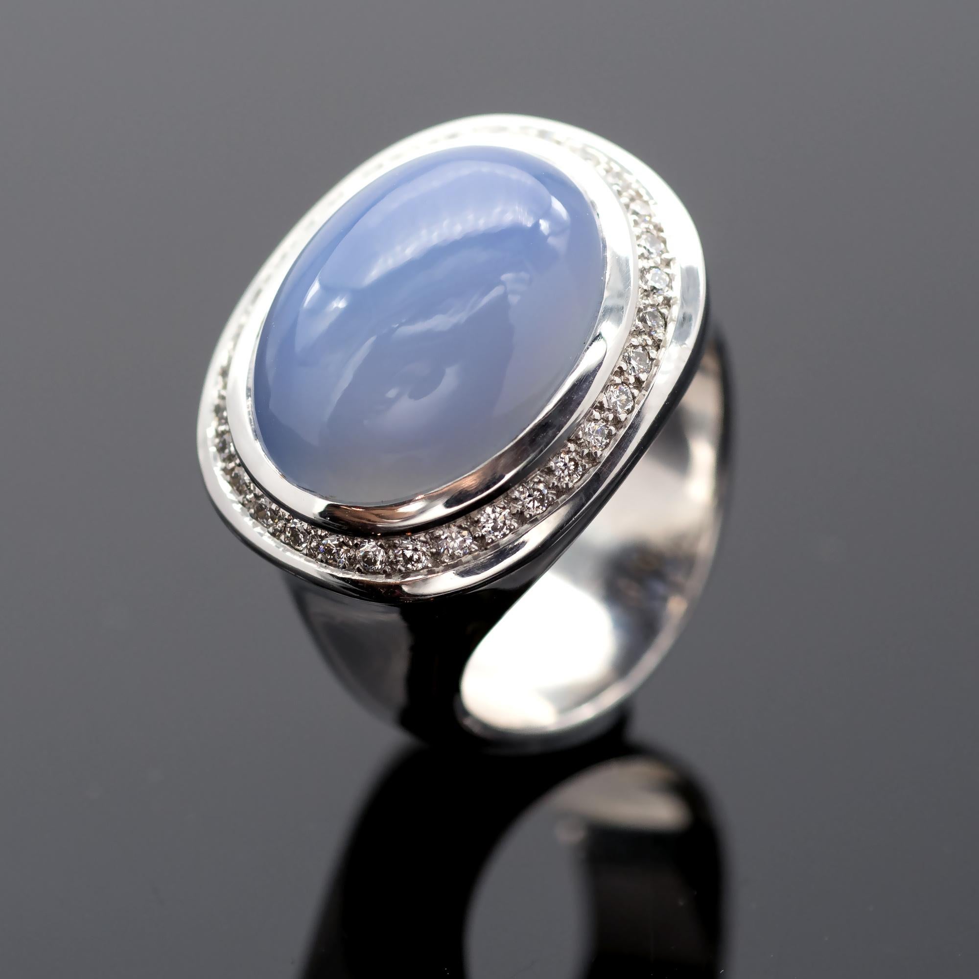 Stylish modern ring with a contemporary design. Perfect lines, hefty 18kt White gold, perfect setting and make this important cocktail ring simple yet powerful. The center chalcedony is bezel set across the finger with a line of brilliant cut