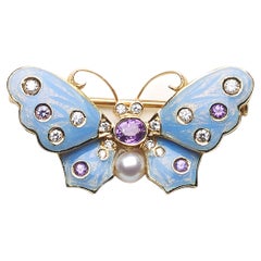 Broche papillon moderne en émail bleu, saphirs violets, diamants et perles
