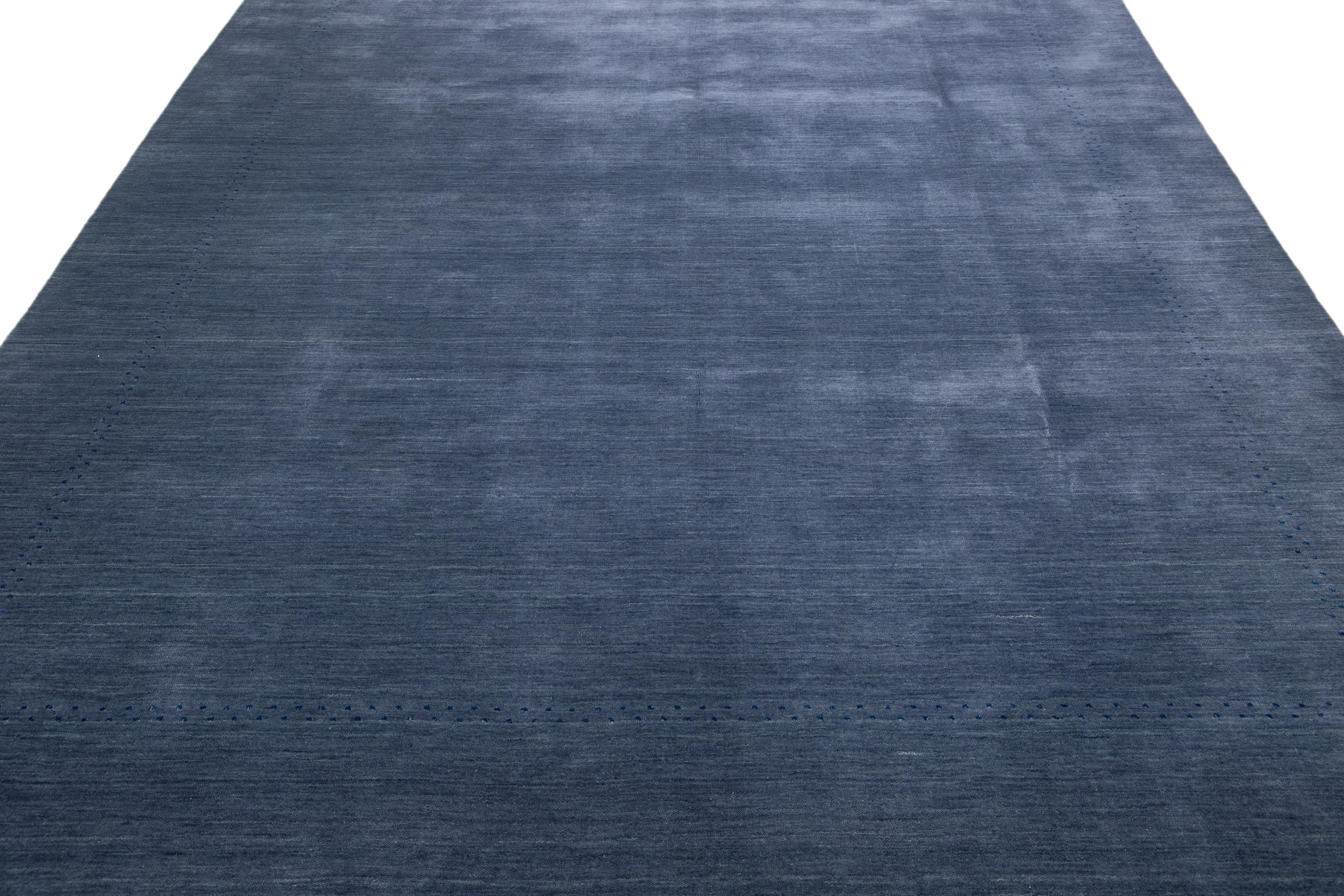 Beautiful modern Gabbeh hand-Loom wool rug with a navy-blue field. This Gabbeh rug has dark blue accents in a gorgeous all-over geometric minimal design.

This rug measures: 8' x 10'.


