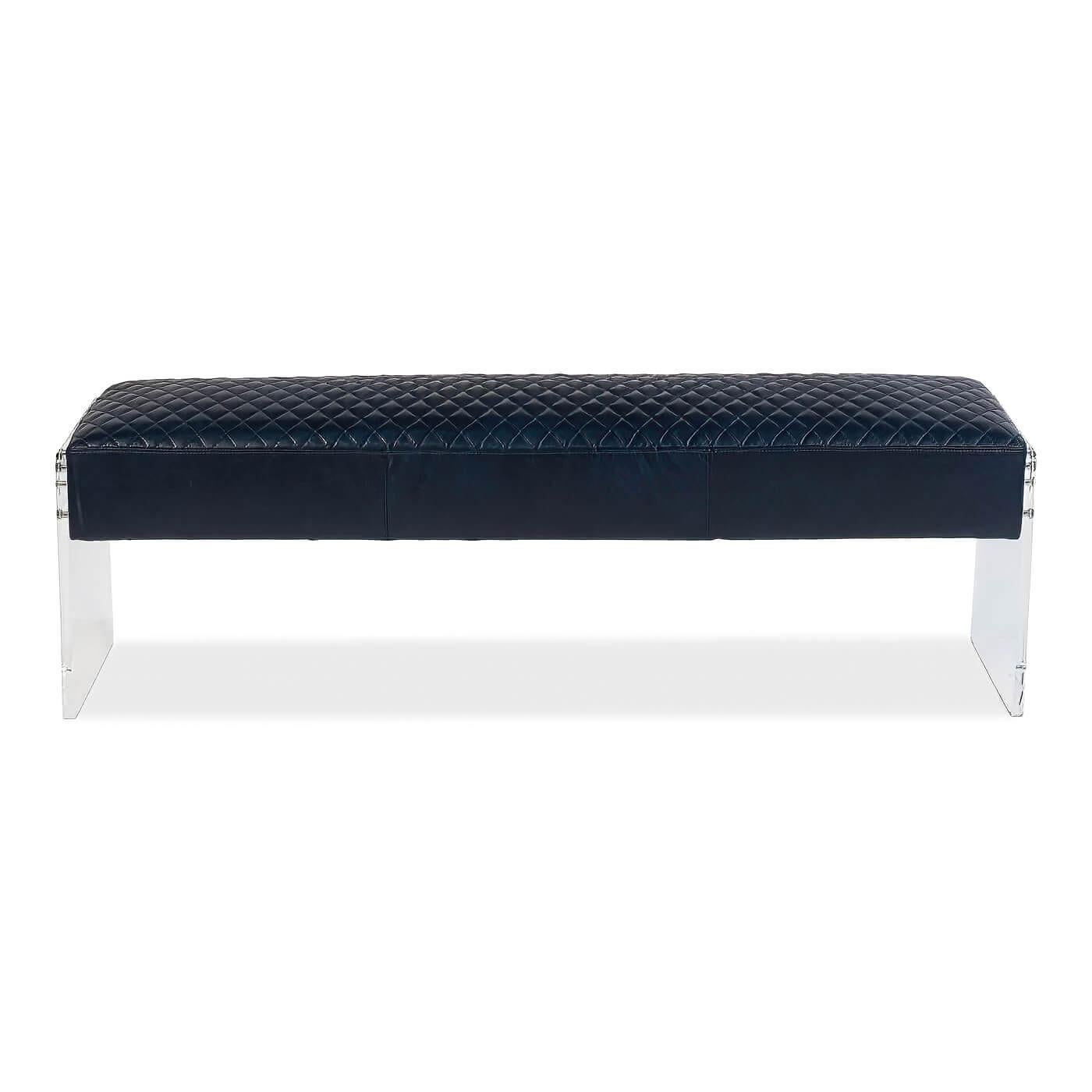 A modern blue leather and lucite bench, elegant blue leather cushion with quilted design rests in between two acrylic lucite legs. This piece has a modern luxurious look and feel. 

Made of pure Aniline top-grain leather in Chateau blue with