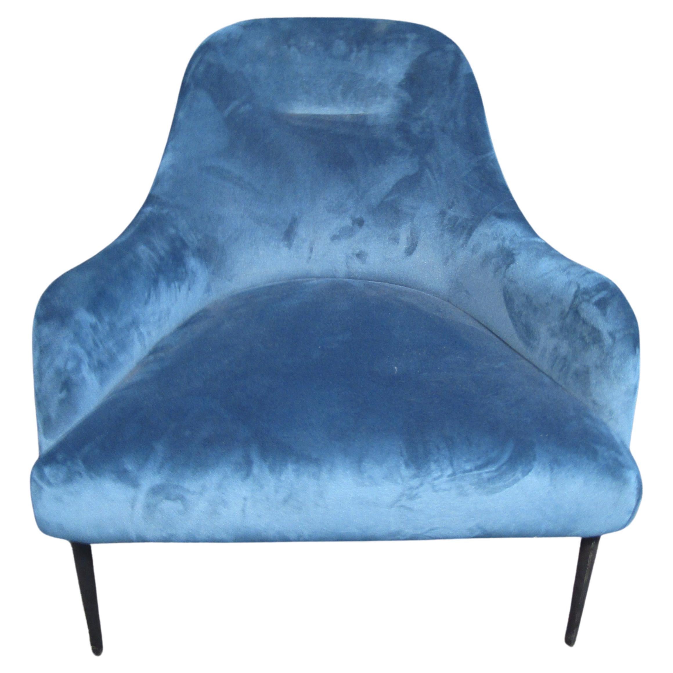 With a comfortable and stylish Mid-Century Modern design, this blue lounge chair adds a pop of color to any interior. Please confirm item location with seller (NY/NJ).