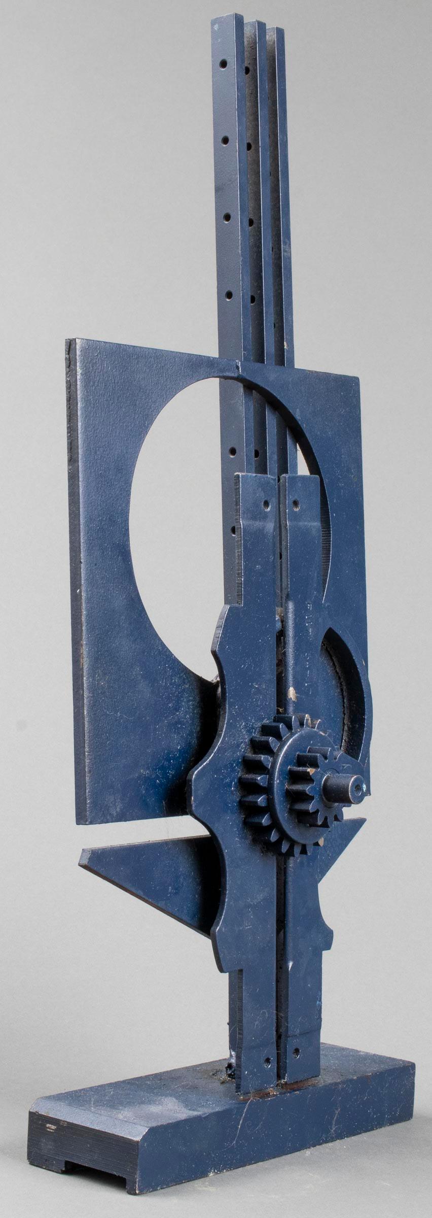 Modern steel sculpture painted in monochrome blue, industrial form with bars and gears, possibly depicting two stylized figures, marked: 