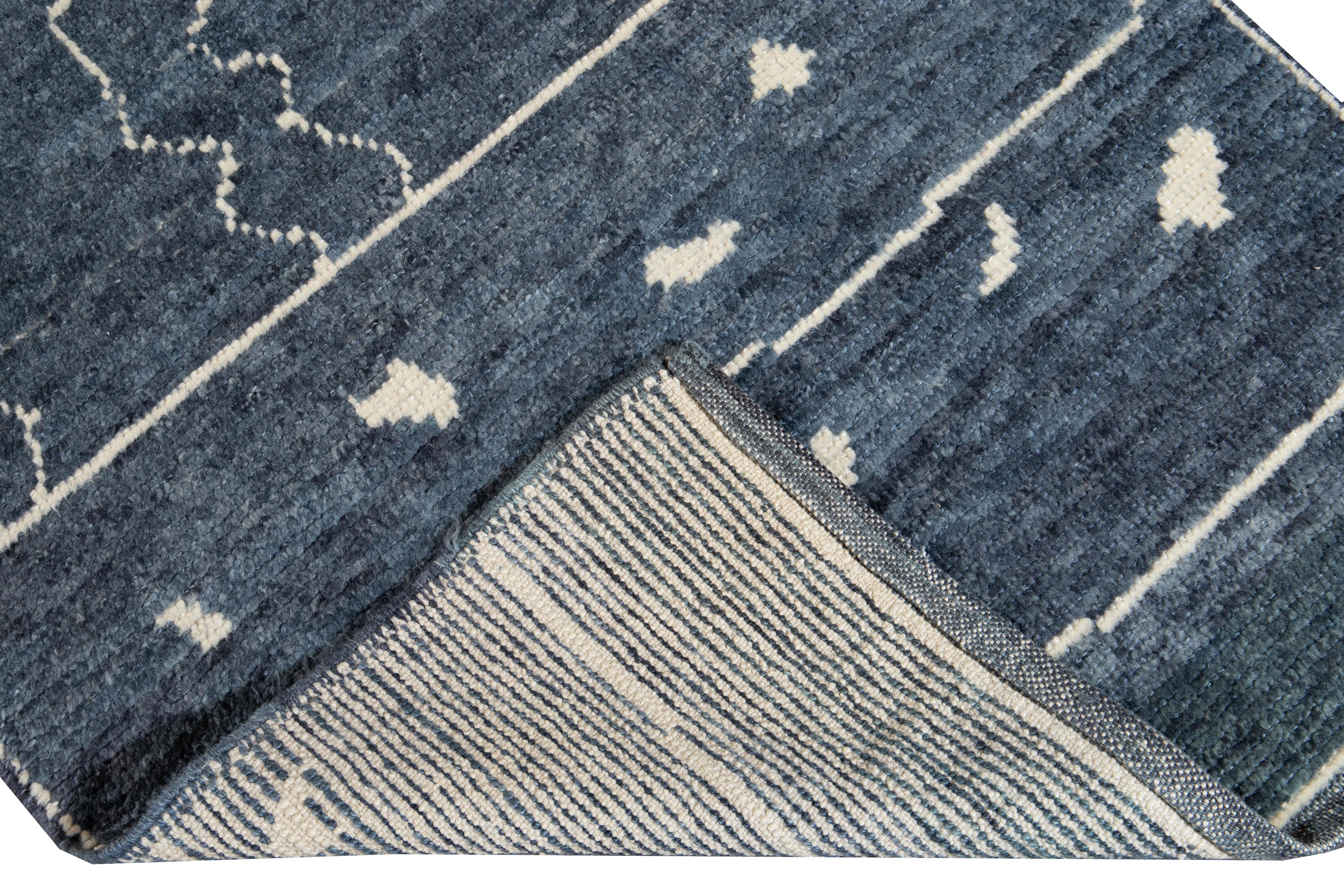 Beautiful contemporary Moroccan style runner hand-knotted wool rug with a navy-blue field. This Modern rug has an ivory accent in a gorgeous all-over geometric tribal design.

This rug measures: 3' x 13'9