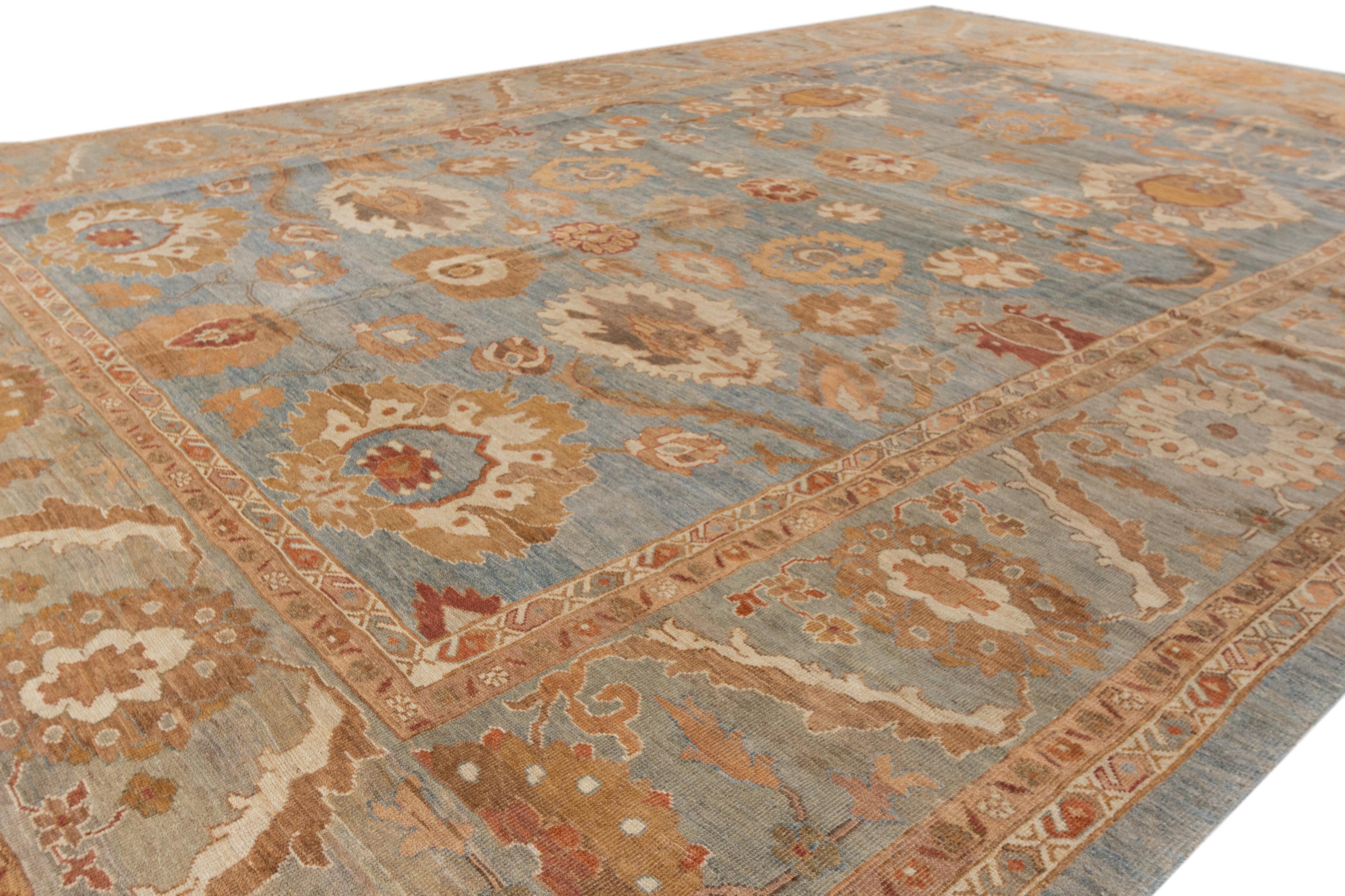 This modern reinterpretation of timeless Sultanabad design is beautifully manifested in a hand-knotted wool rug, resplendent in its striking blue shade. An intricate border delineates its all-over floral embroidery, embellished with multicolored