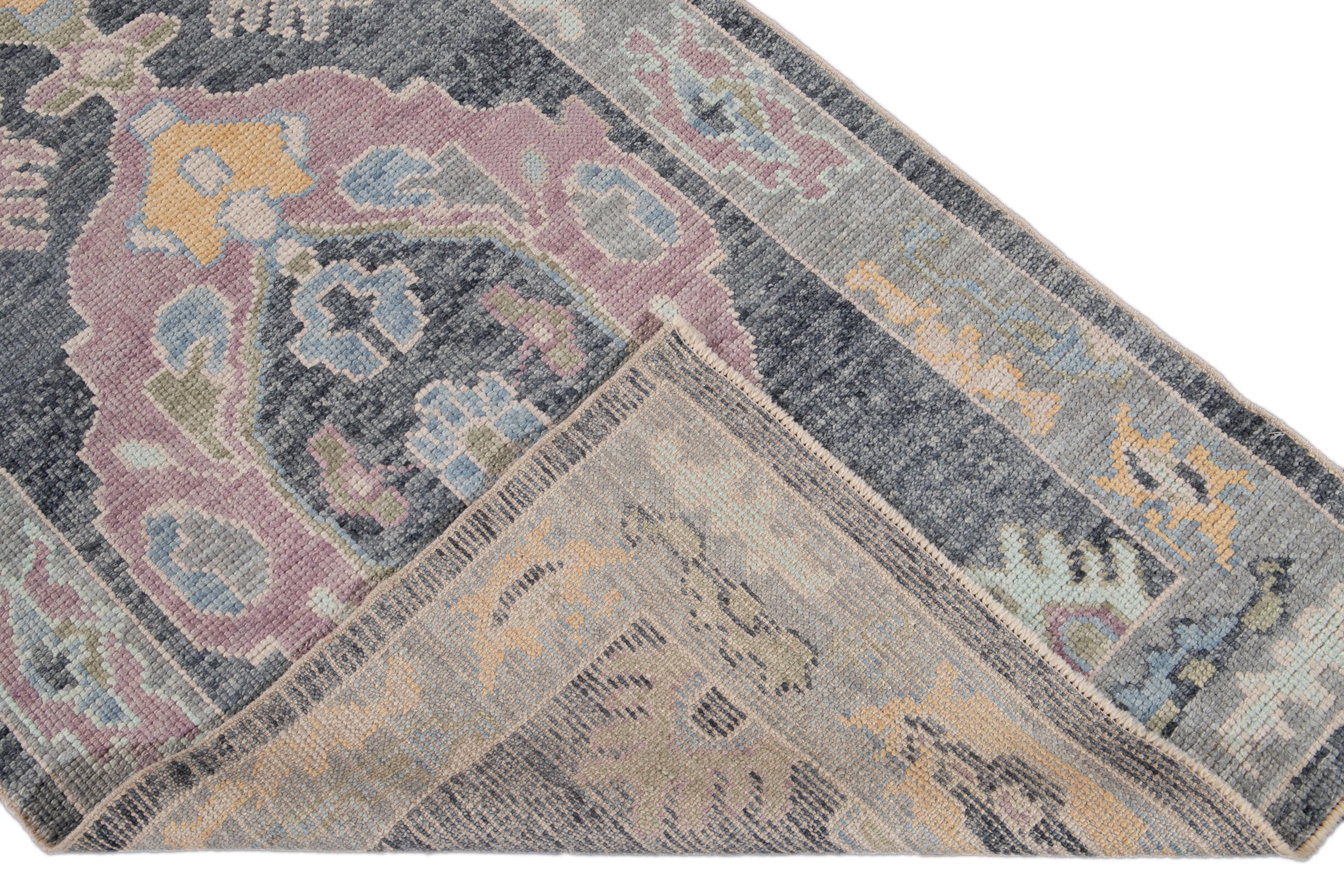 Beautiful modern Oushak hand knotted wool runner with a navy-blue field. This Oushak runner has a gray frame and accent of yellow, green, purple, and green in an all-over gorgeous medallion floral design.

This runner measures 3'2